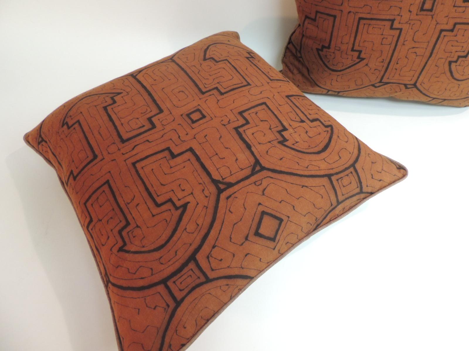 Pair of graphic tribal orange and black decorative pillows. Accentuated with small welt linen trim. Same as backings.
 In shades of black, orange and brown. Decorative pillows handcrafted with an artisanal textile from South America. 
Handcrafted