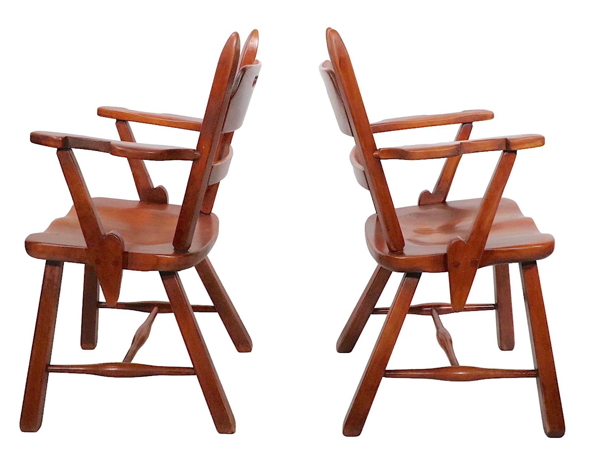 Exceptional pair of Herman de Vries Colonial Creation model 4125A maple arm chairs. This series illustrates early modern applied design produced by Cushman Manufacturing of Vt. circa 1930s, the arm chairs are particularly successful. These chairs