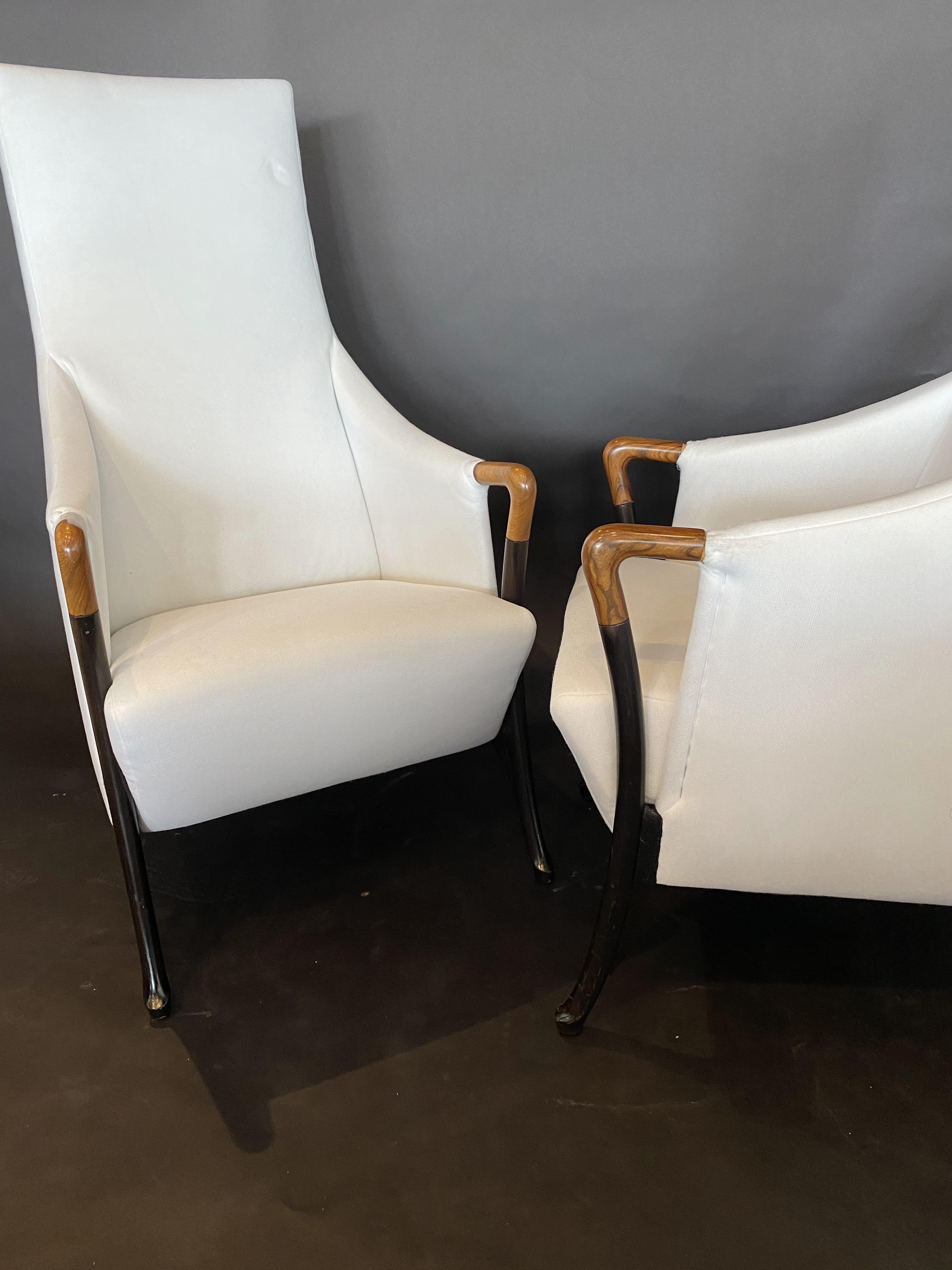 The high upholstered back and seat, with sweeping walnut arms and handrests, over splayed ebonized legs.
Umberto Asagno started working for Giorgetti in 1968, and became head designer and led their research center for design. He is currently