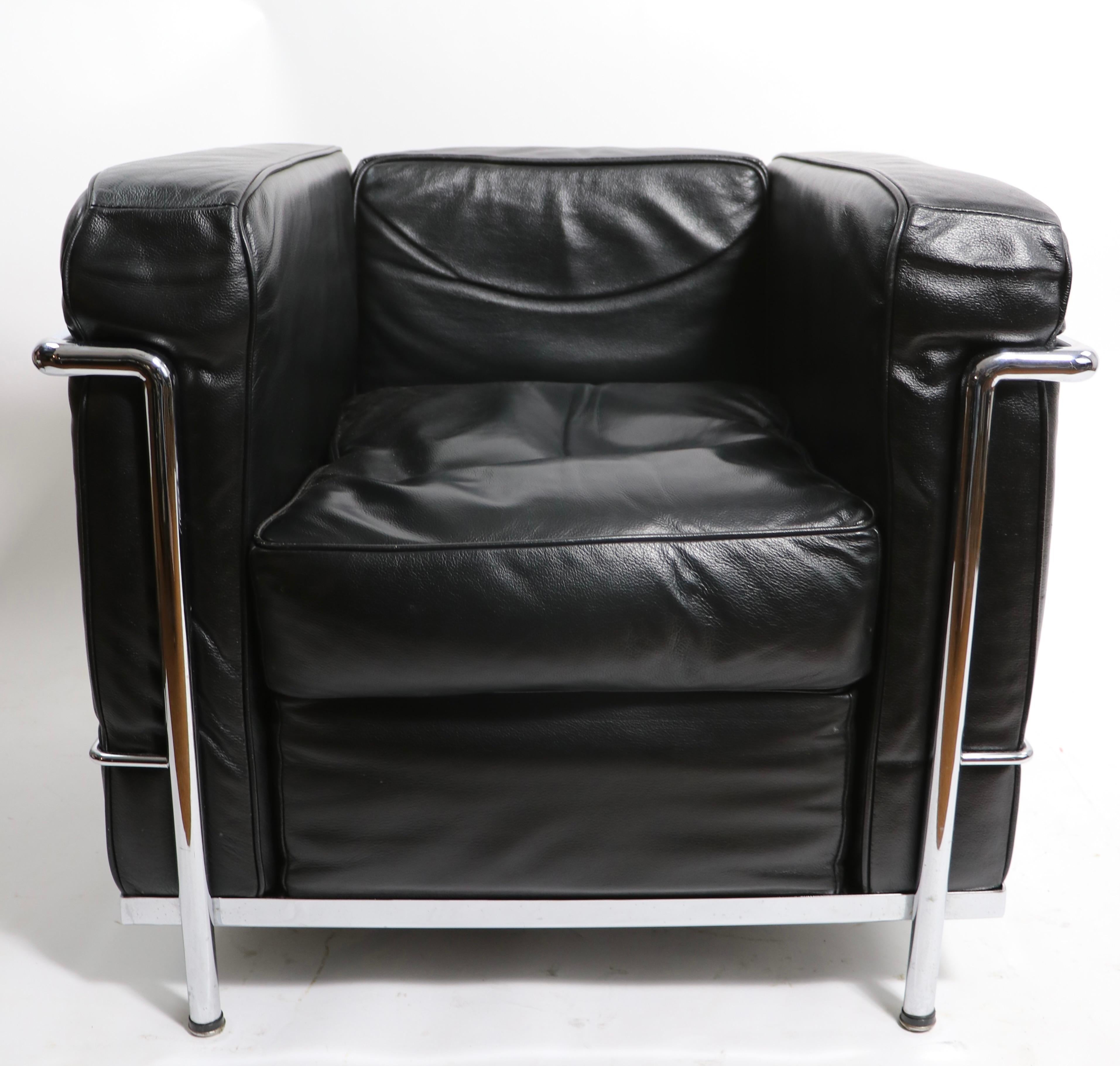 Exquisite pair of LC2 Petite Modele armchairs in bright chrome with black leather cushions. These chairs are vintage 1970's, probably made in Italy, unsigned. Both are in very fine, original condition, clean and ready to use. Iconic Bauhaus design