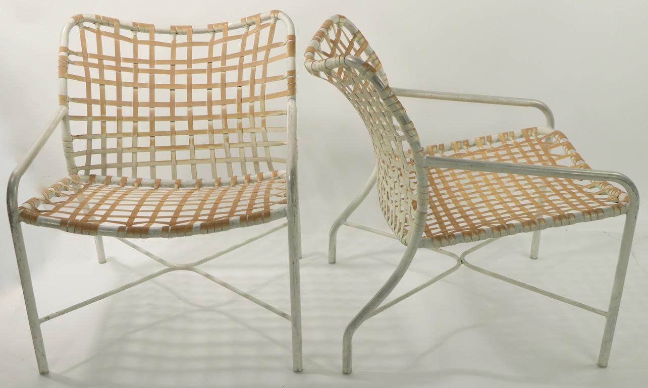 Pr. Brown Jordan lounge chairs designed by Tadao Inouye for Brown Jordan, circa 1970s. Both are structurally sound and sturdy, both show significant cosmetic wear to paint finish and webbing. Offered and priced as a pair. 
 Total H 28 x Arm H 20 x