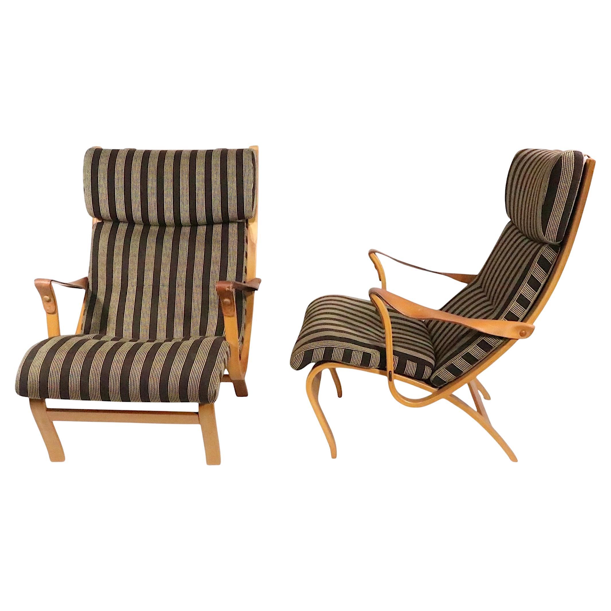 Chic pair of Clipper  lounge chairs designed. by Soren Nissen & Ebbe Gehl, made in Denmark by Jeki Mobler circa 1970's. The chairs feature bent wood frames, upholstered sling seats, and leather strap arm rests. Both chairs are in very good,