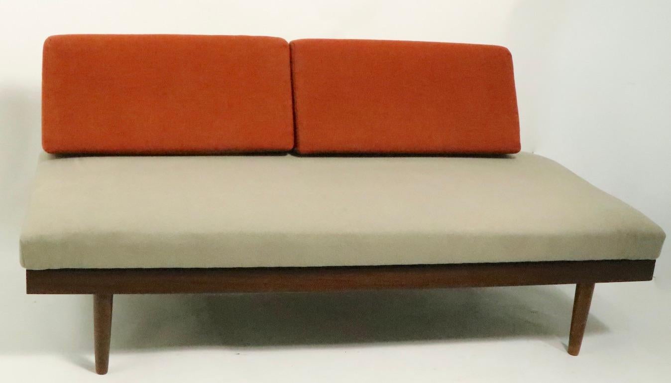 Classic Danish Modern Mid Century daybed, made in Norway, designed by Ingmar Relling for Ekornes. The sofa can be used as a sofa, loveseat, and or daybed as the sides pull out and can become side table surfaces or support the backrest cushions,