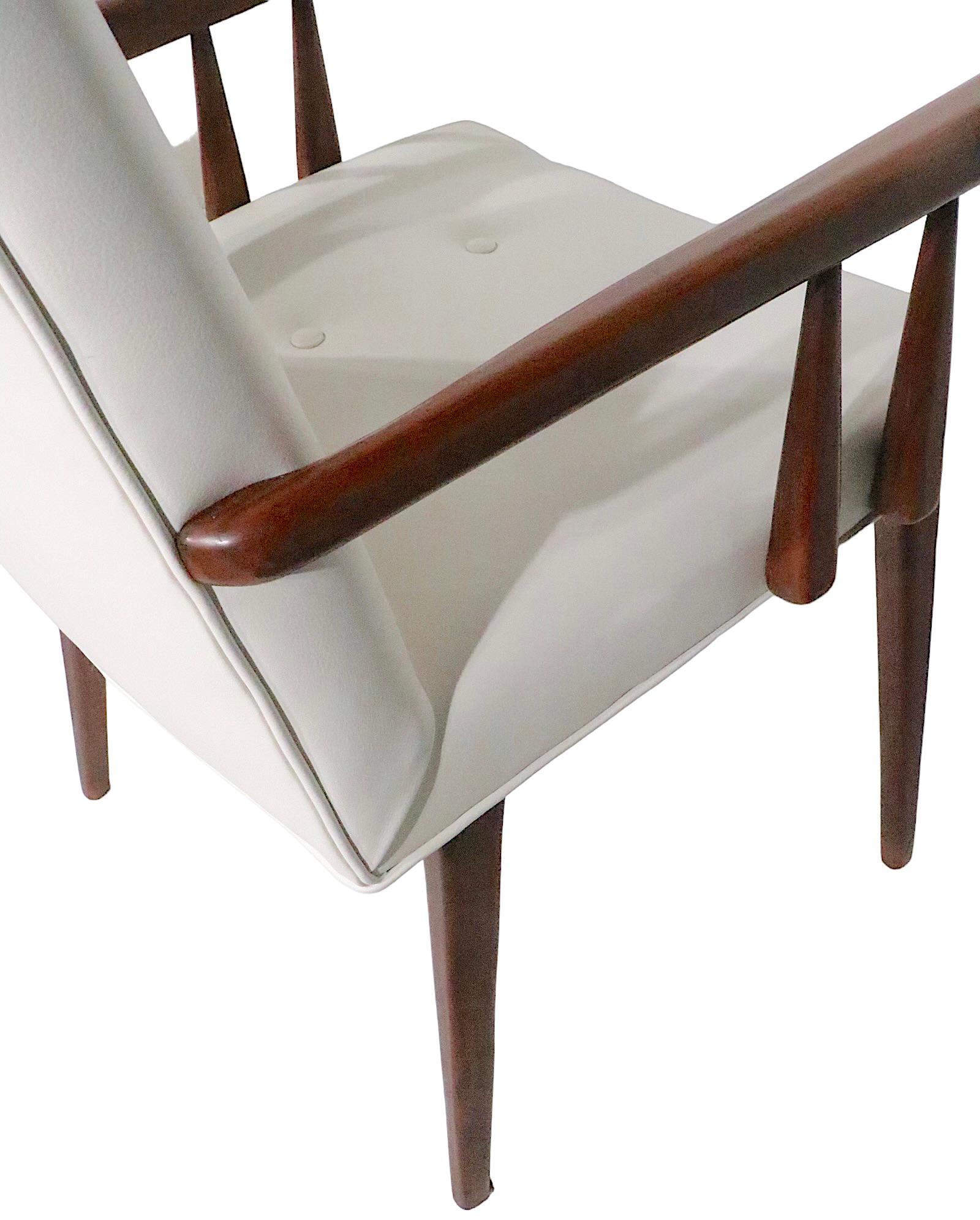 Chic and sophisticated pair of dining height arm chairs, attributed to George Nakashima for Widdicomb, unsigned. The chairs have been newly reupholstered in white leather, and are in excellent, clean, ready to use condition. 
 Total H 37.5 x Arm H