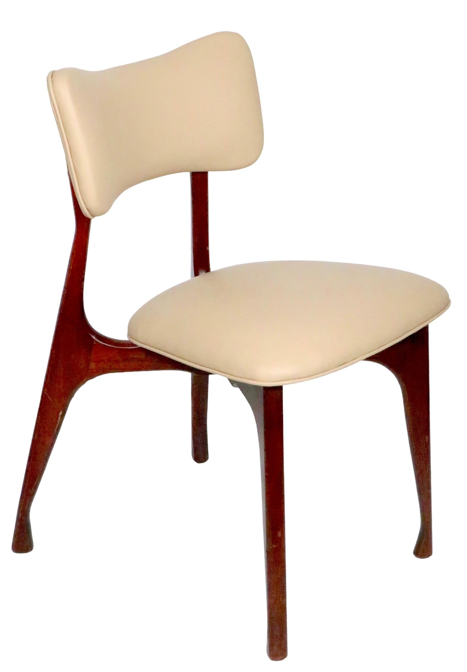 Chic sophisticated design mid century side chairs, in newly reupholstered ecru leather with sculptural wood frames. Italian made, attributed to Ice Parisi, circa 1940- 1950's. Both chairs are structurally sound and sturdy, the wood finish shows