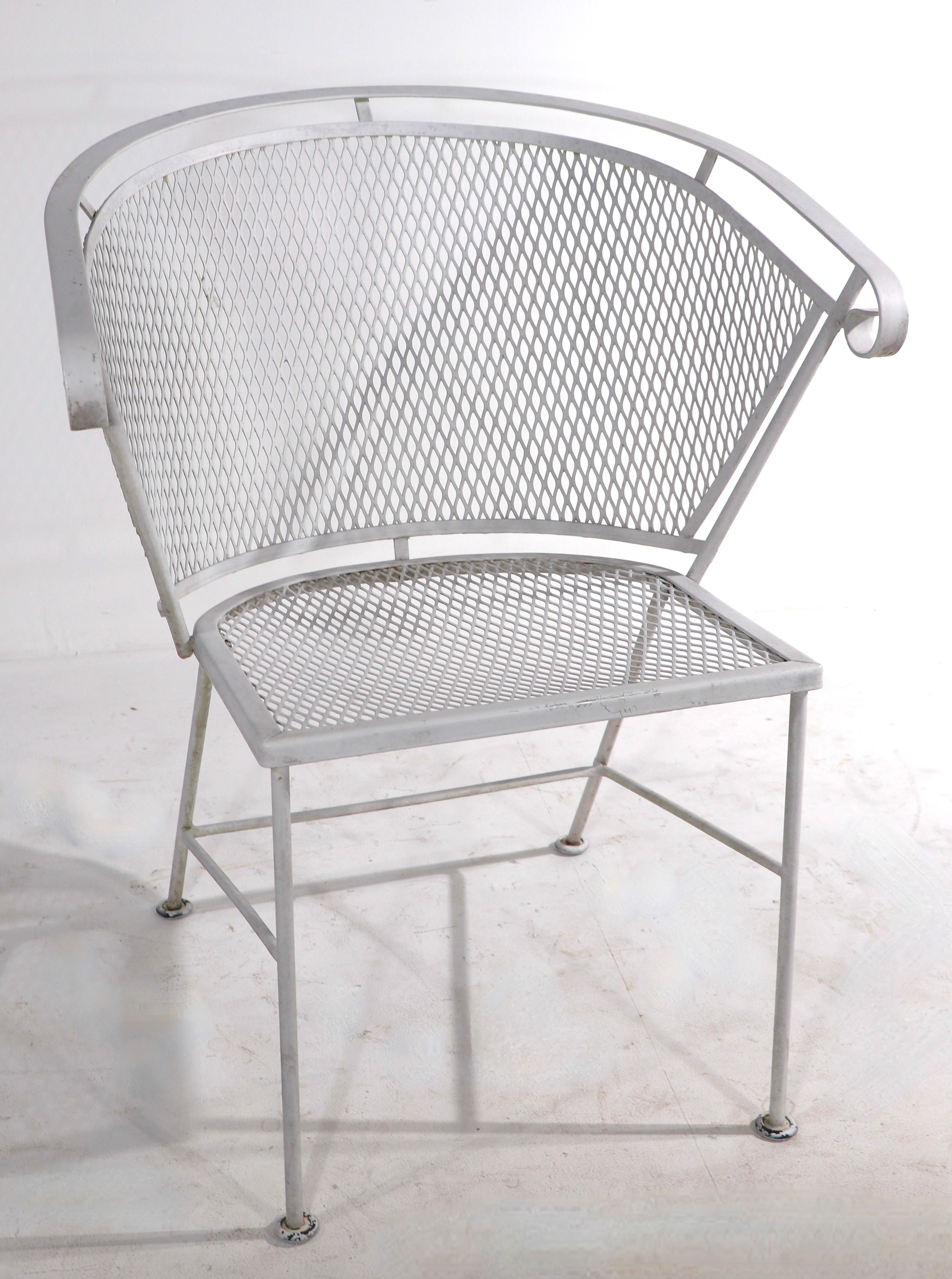 Pair of stylish mid century garden, patio, poolside lounge, dining chairs of wrought iron and metal mesh. Both chairs are in very good condition, showing only light cosmetic wear, normal and consistent with age. Usable as is or we offer custom