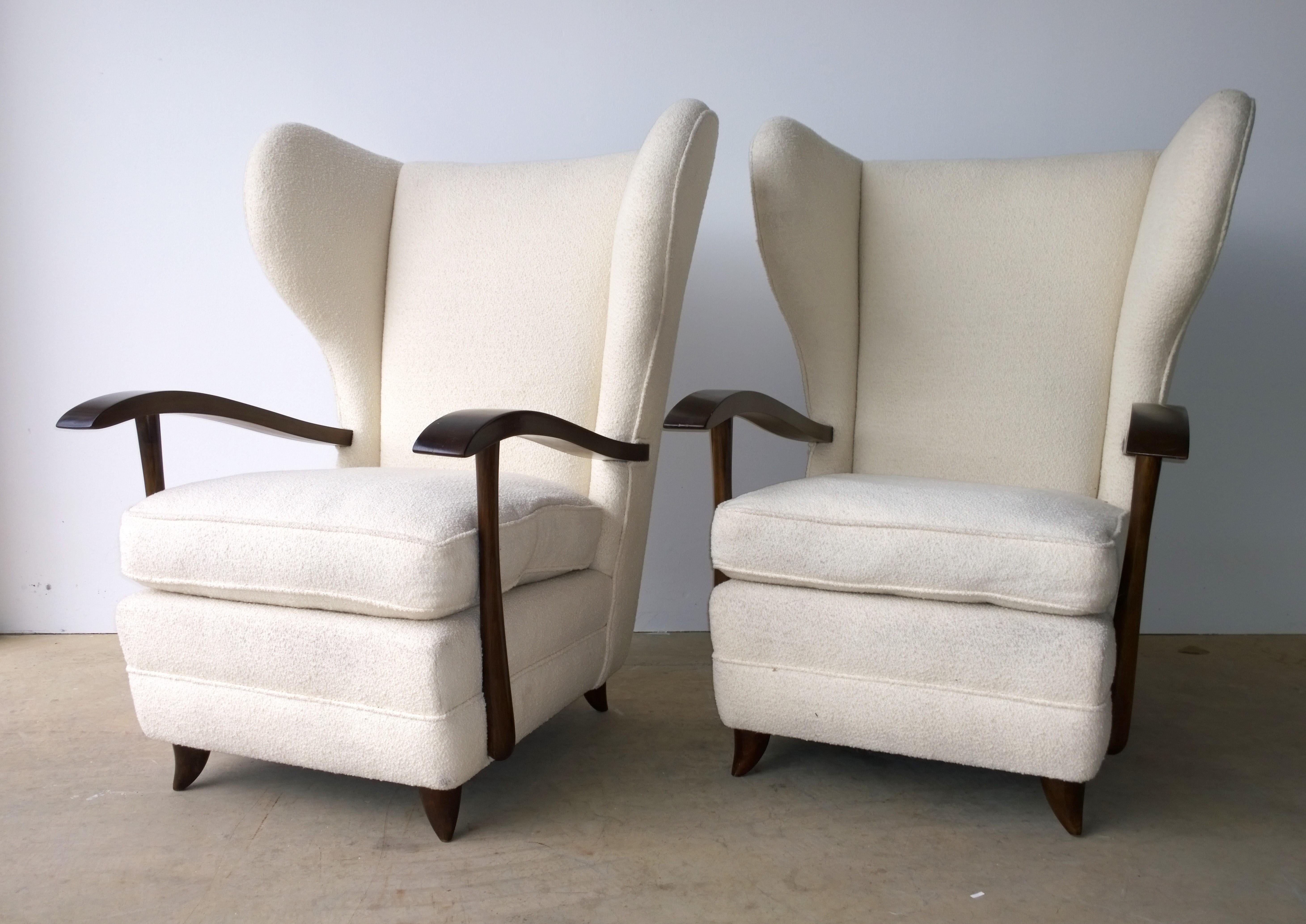 Offered is a pair of Mid-Century Modern Italian Paola Buffa attributed arm or lounge chairs with mahogany sculptural arms and upholstered in a white wool bouclé. The pair was purchased with the upholstery intact. Most likely the upholstery was