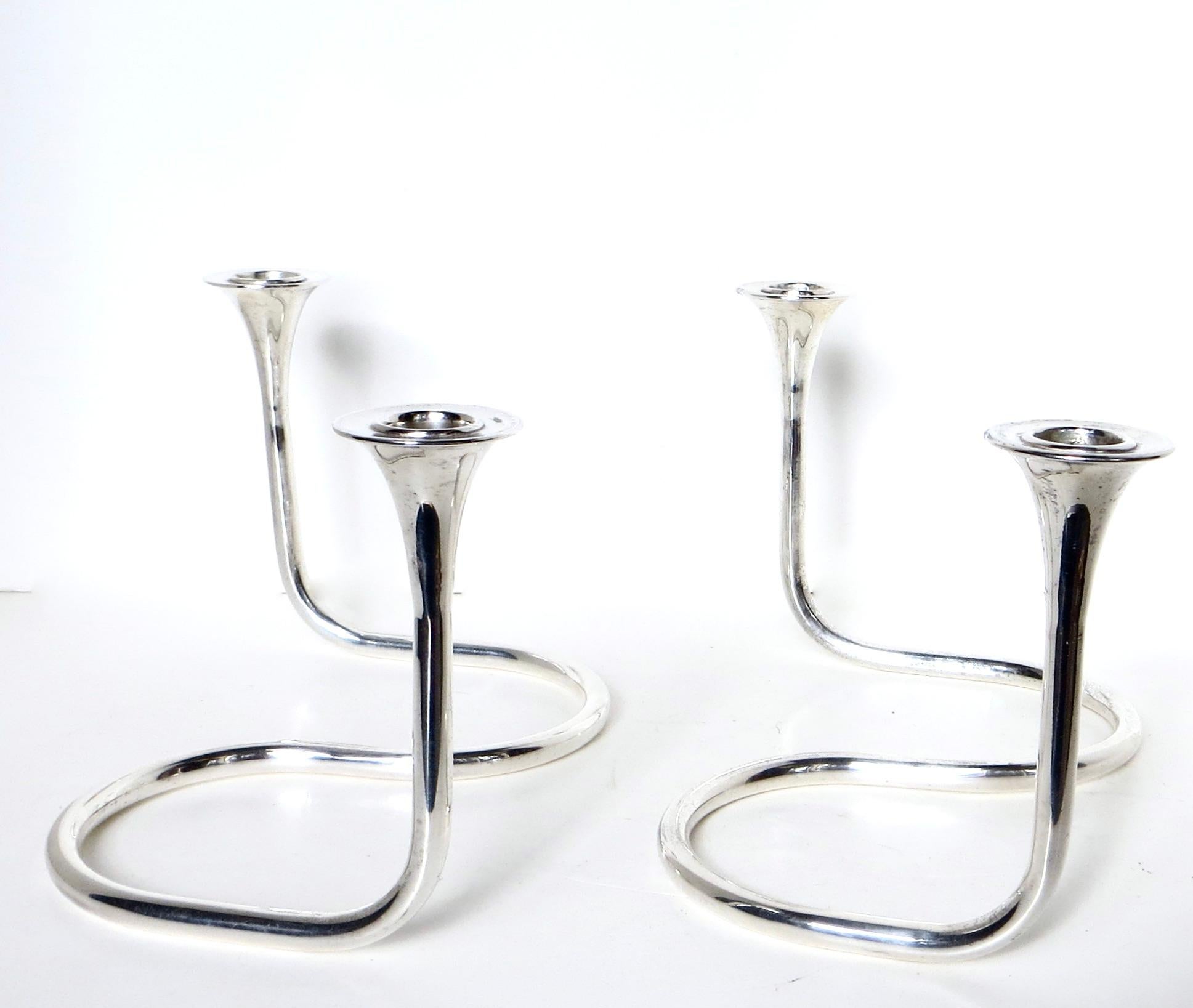Offered is a unique pair of sterling silver serpentine Mid-Century Modernist candleholders. They are of fine quality holloware tubular design, weighing 173 grams each (6 oz.) for a total of 346 grams the pair. The contemporary 