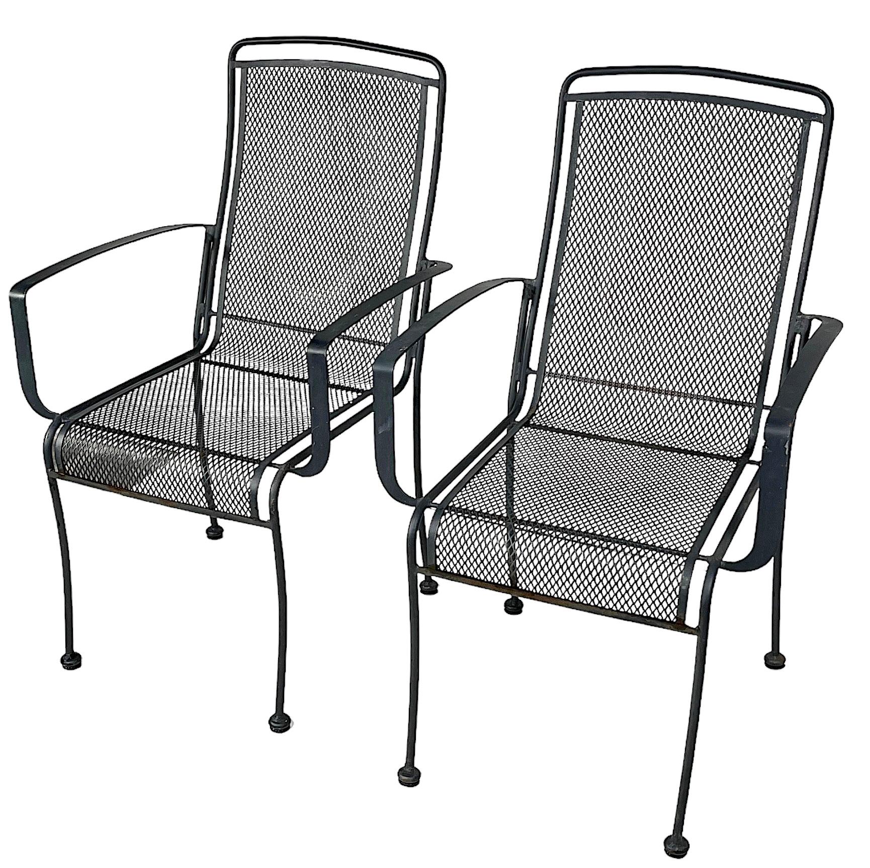 Pr. metal garden, patios or  poolside, dining height arm chairs attributed to Woodard, in the style of Tempestini, circa 1970/980's. The chairs are in good, original condition, showing only light cosmetic wear to finish normal and consistent with