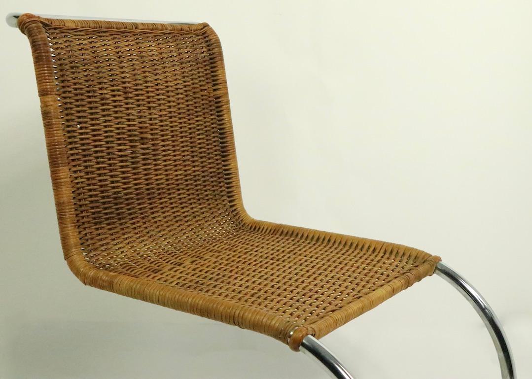 Iconic design mr 10 chairs designed by Ludwig Mies van der Rohe. These chair are circa 1960s-1970s, we believe they were made in Italy for Knoll, but they are unsigned. Both are in good condition, but both show minor flaws to the woven wicker, which