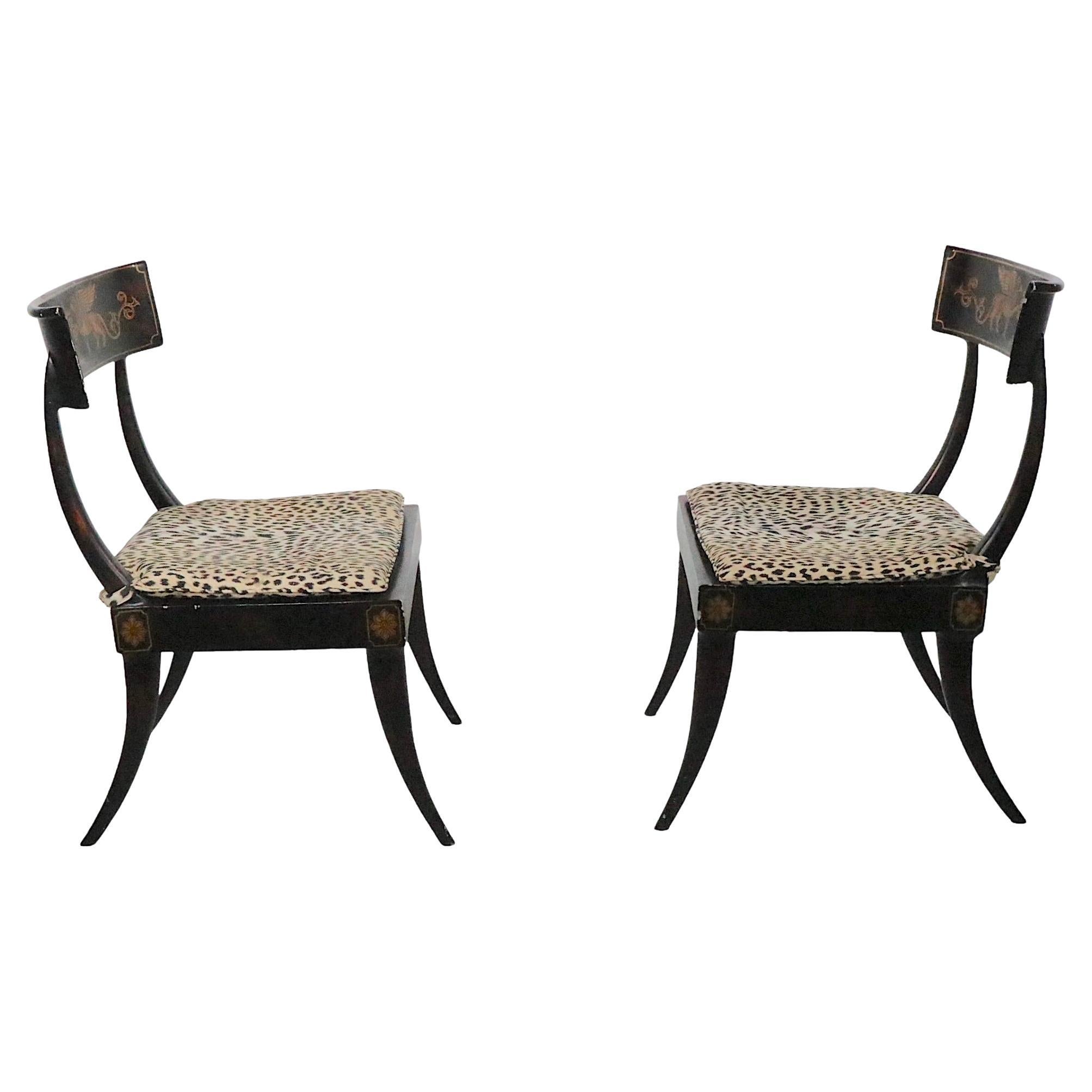 Exceptional pair of Italian neoclassical side, or dining chairs, constructed of metal with faux gilt decoration, and chic leopard print seat cushions. The chairs are in very good, original condition, showing minor loss to pint finish, normal and