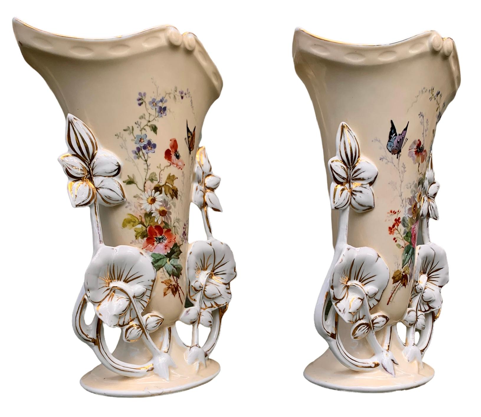 A superb pair of Old Paris porcelain garniture vases having lovely enameled, hand painted floral studies on a pale beige background and with gilt decoration. These are circa 1850. 

These exquisite vases would be lovely on your favorite mantle,