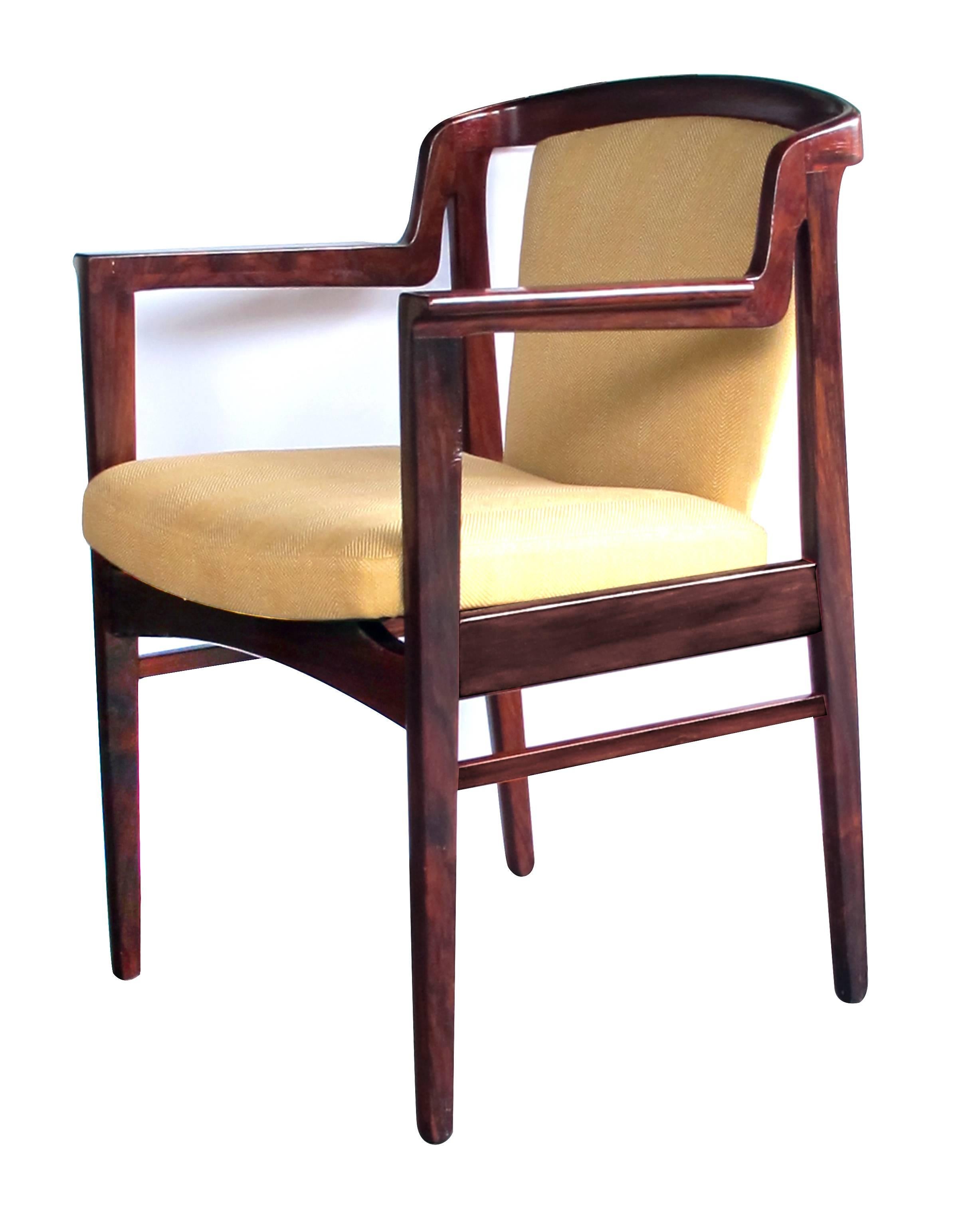 A good pair of Danish modern 1960s rosewood arm chairs in the manner of Kai Kristiansen; each with sculptural profile, the incurved back with padded splat above a tight seat flanked by knife-blade arms; all raised on tapering supports; with new