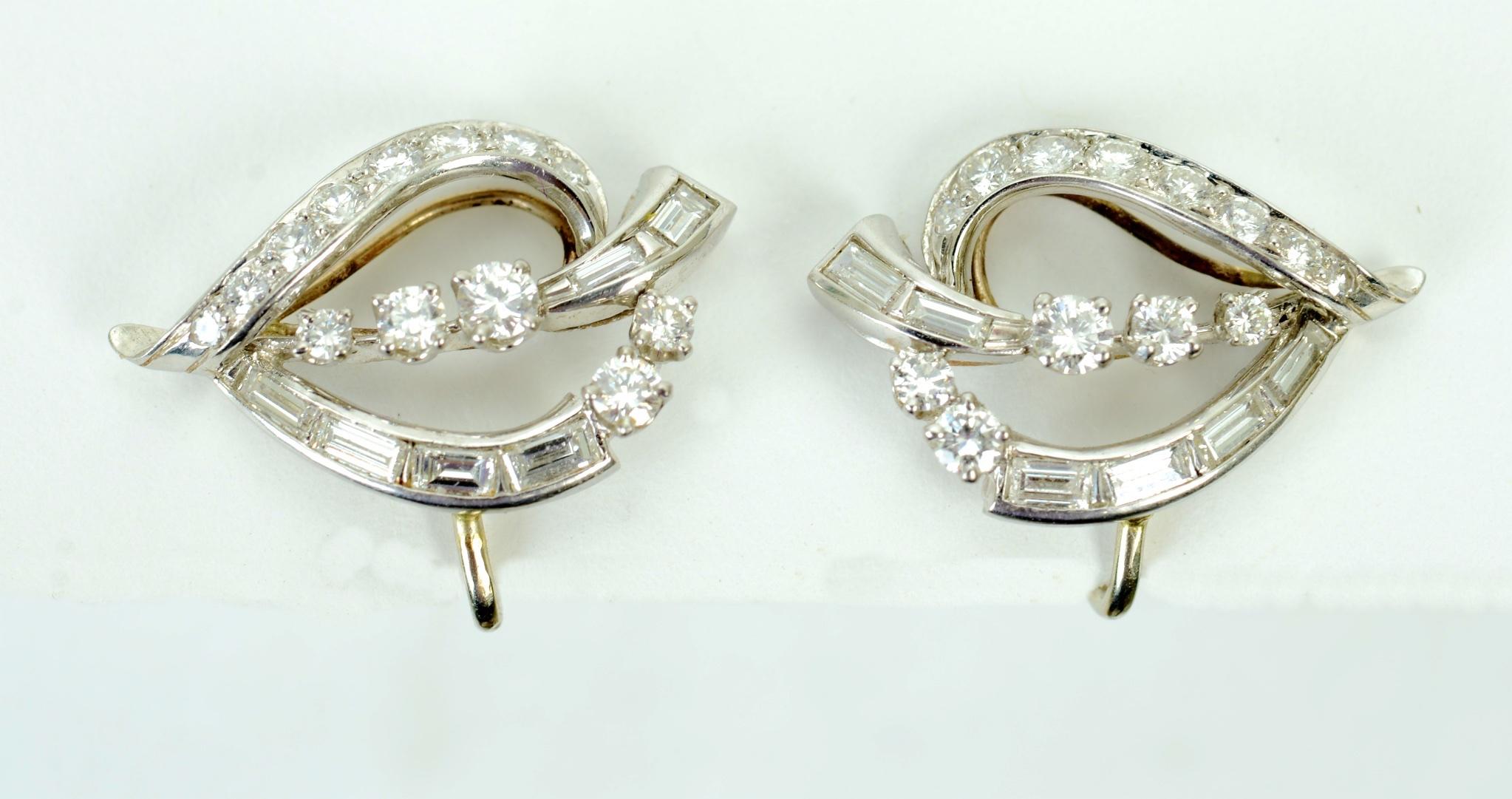 Pair of Open Leaf Shaped Diamond Ear Clips Mounted in Platinum and 14K White Gold1 weighing approximately .85 Carats each, Late Retro c1950. They have patented screw backs with wide ear platforms for added safety and comfort. Each earring is set