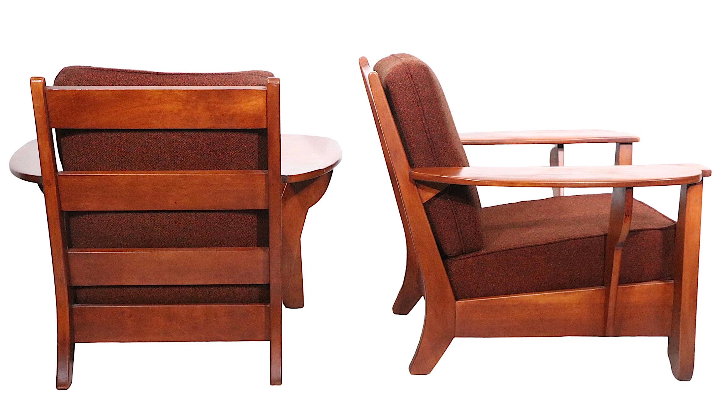 Exceptional and rare pair of Herman de Vries design for H.T. Cushman as part of the sought after Colonial Creations series. The chairs feature an exaggerated wide paddle form arm, and an unexpectedly sophisticated and chic low profile. 
 Solid