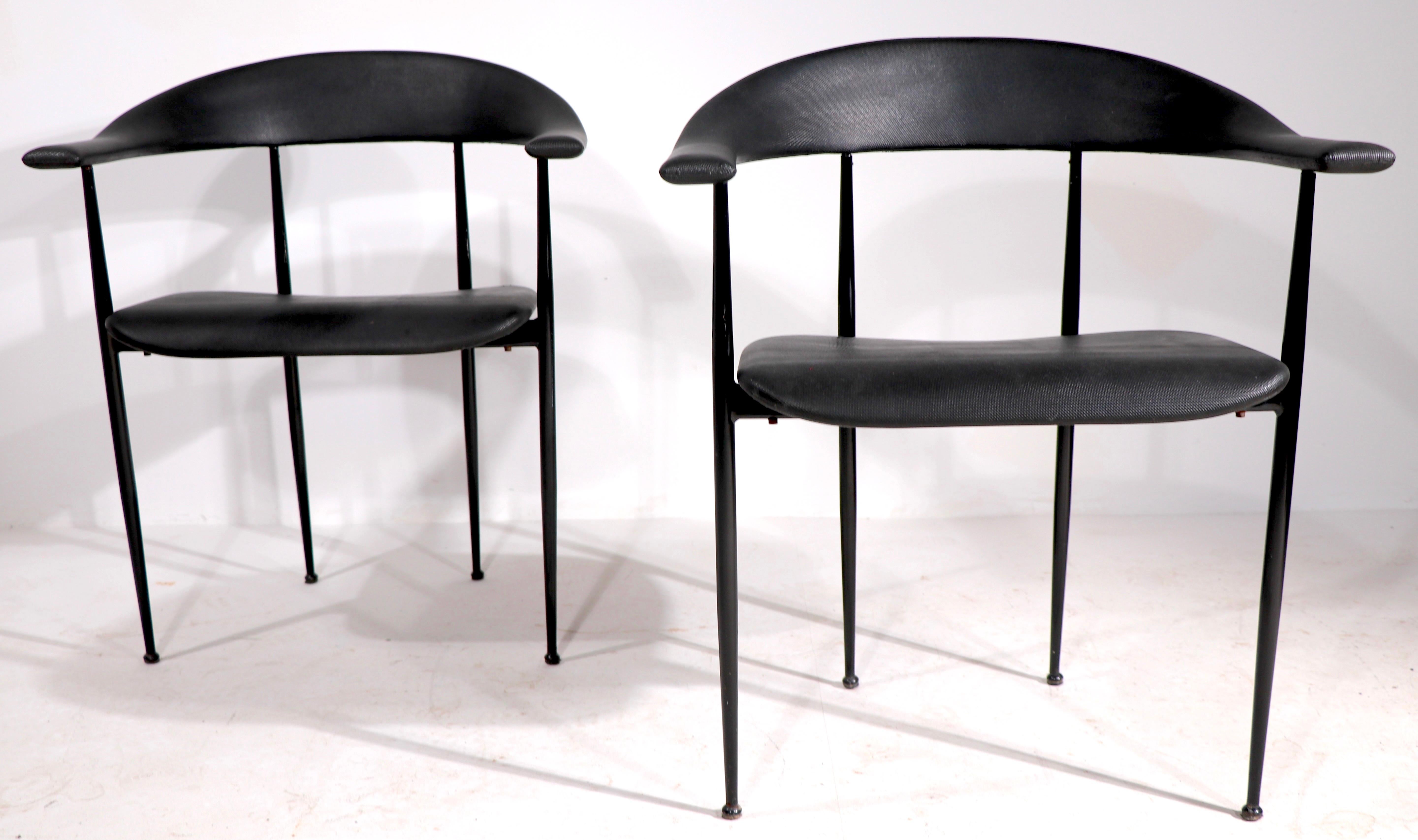 Stylish pair of post modern design chairs, made in Italy, retailed by Conrans Habitat NYC in the 1990's. Very fine, original clean and ready to use condition. Textured rubber upholstery, on slick black metal frames. 
Total H 29.5 x arm H 25 x seat
