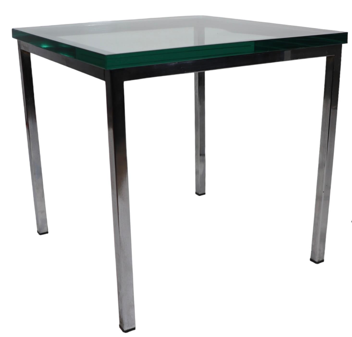 Pair of chic architectural Bauhaus, International, Post Modern style endear side tales. The tables feature bright chrome bases of squared metal, which support nice thick ( .75 in. ) glass tops. The tables are in good overall condition, with minor