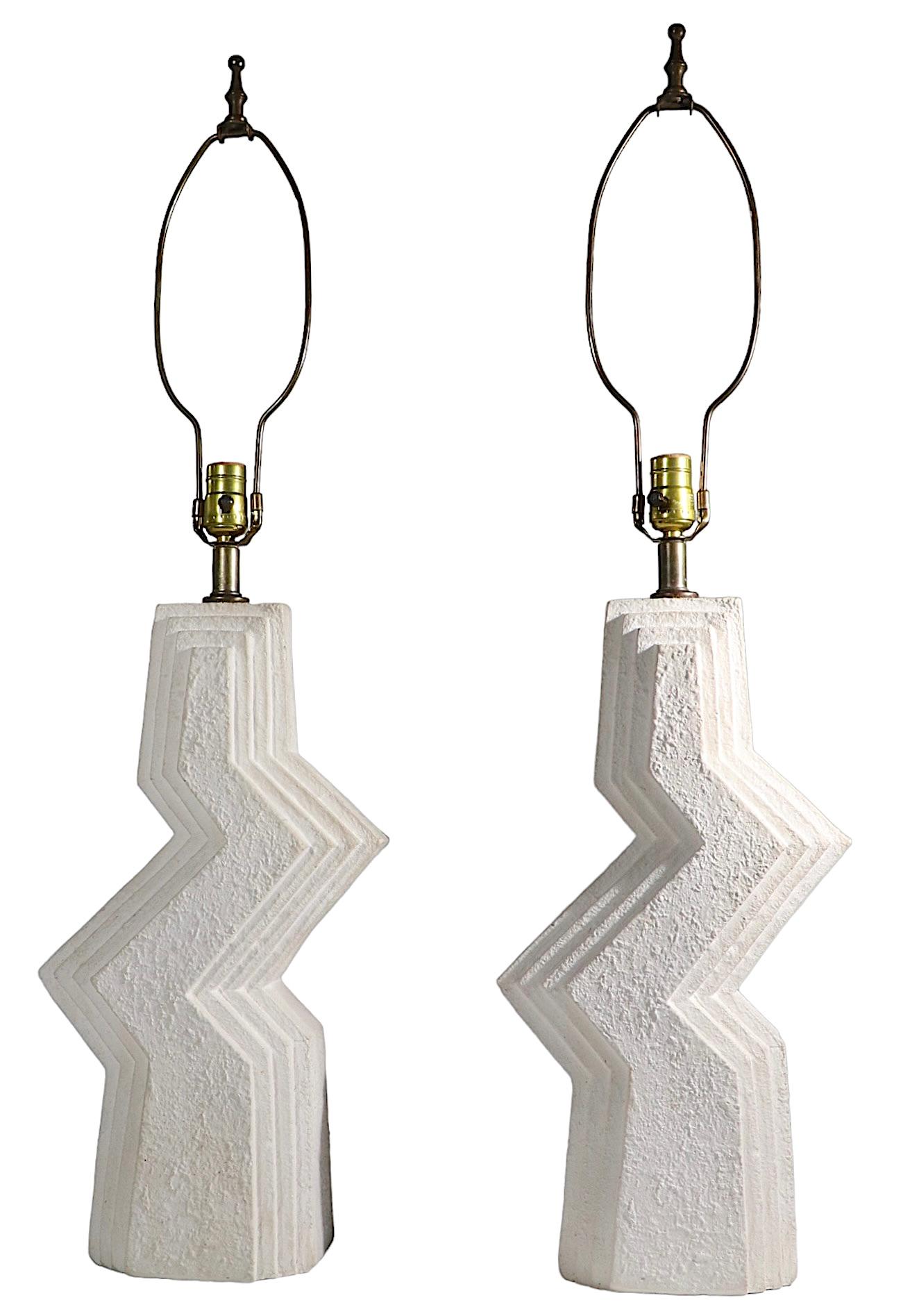 Chic pair of off white cast plaster zig zag table lamps, by Ziggurat, circa 1980's. Both are in very good, original clean and working condition, shades not included. Free of chips, cracks or repairs, both show minor cosmetic wear, normal and