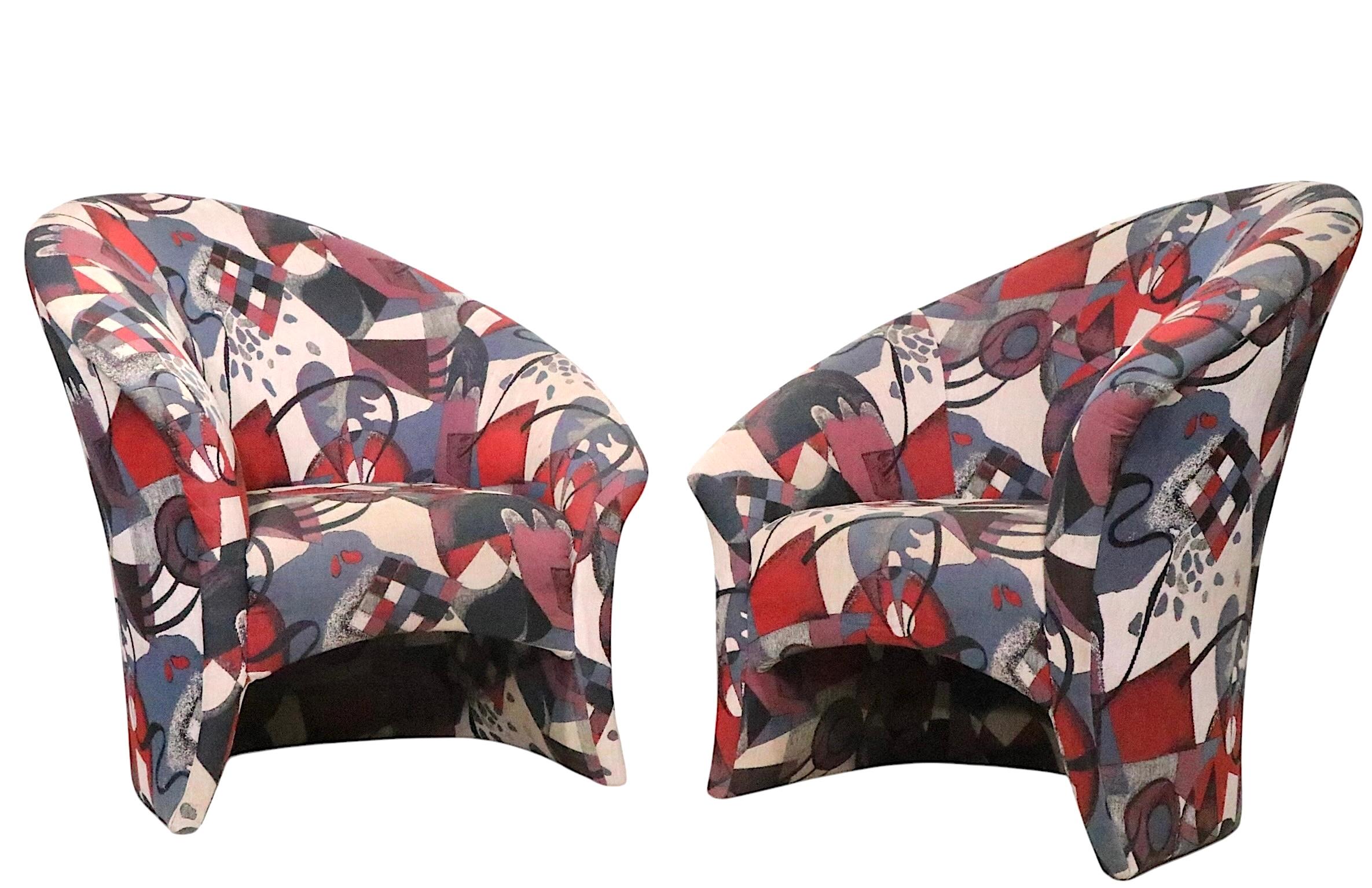 Exceptional Post Modern asymmetrical lounge chairs, in exuberant upholstered print fabric. Both chairs are in very good, both show inconsequential wear to the fabric, minor stains etc, please see images.  Made in the USA circa 1990's, in the style