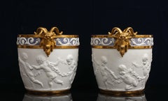 Pr Sevres Biscuit Porcelain Putti Decorated Centerpieces w Gilt Rams Head Handle