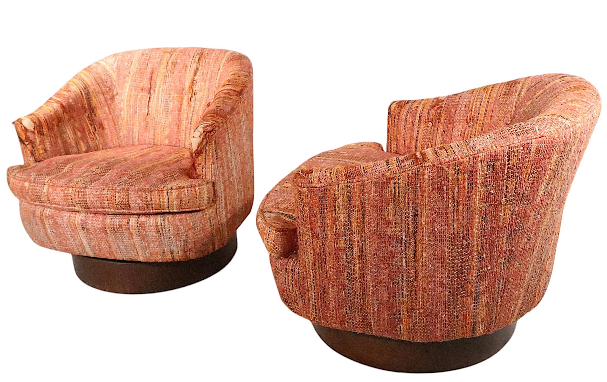 Pair of swivel tub chairs on disk for plinth bases.  Both are fully functional, structurally sound and sturdy, both need to be reupholstered.  Circa 1970's. made in the USA - Reminiscent of the designs of Milo Baughman, these examples are unsigned.