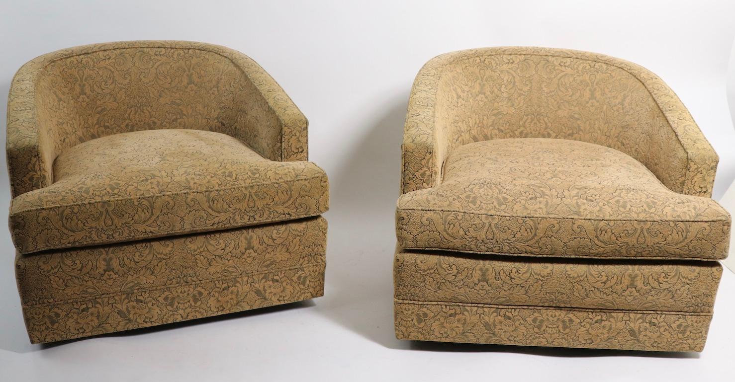 High quality pair of swivel tub chairs in chenille damask fabric. Sleek low slung profile, simple lines will look great in both modern and traditional interior spaces. The chairs are in very good, original condition, clean and ready to use as is or