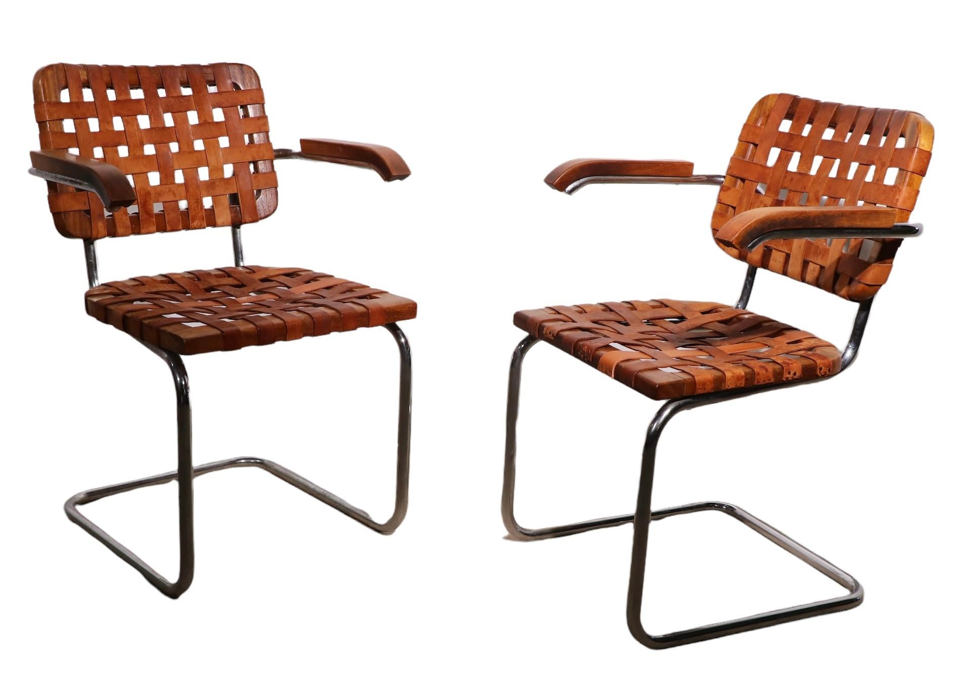 Unique leather strapped version of the iconic Cesca chair, designed by Marcel Breuer. These chairs were made in Italy, circa 1970's. Both are structurally sound and sturdy, both show cosmetic wear, and signs of age and use, including some replaced