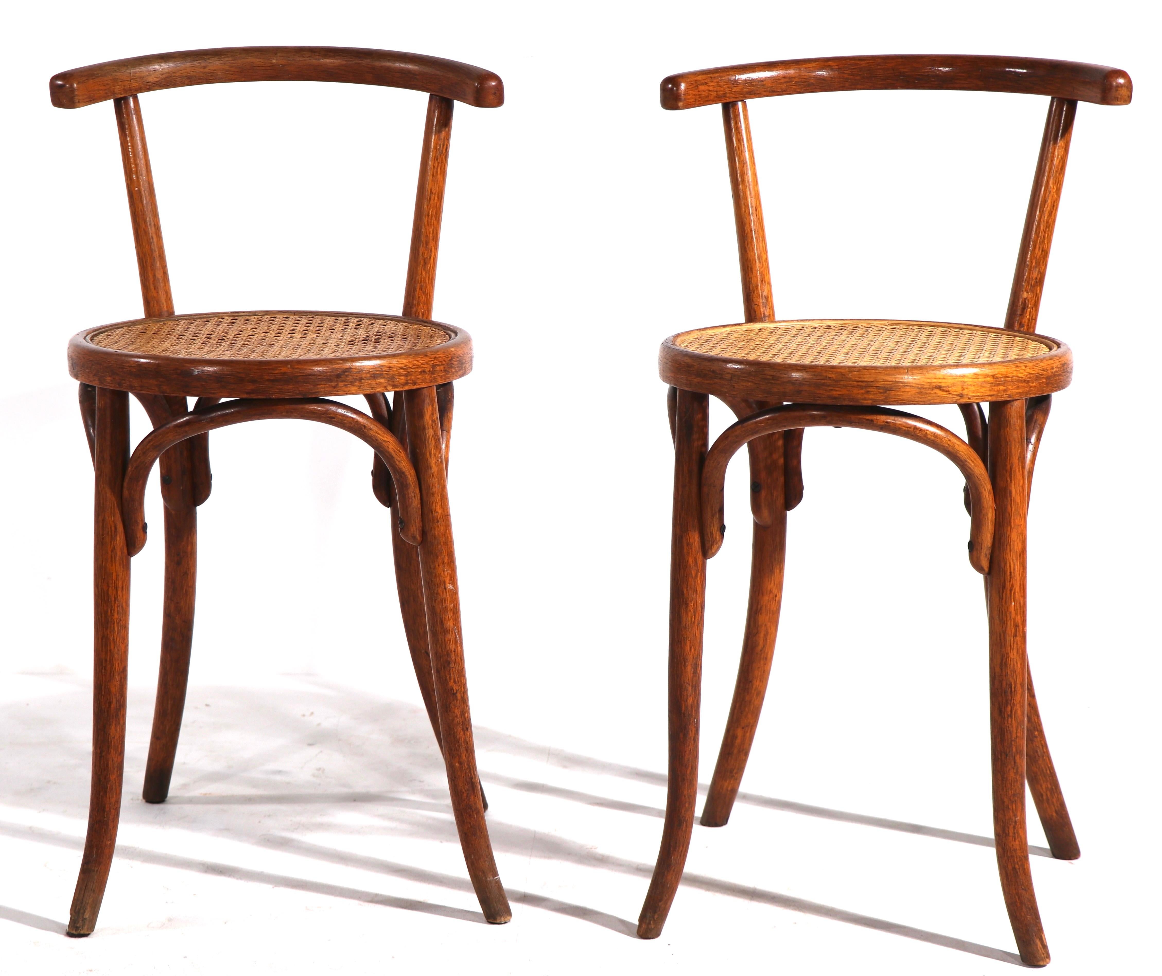 Sophisticated pair of bentwood chairs made in Czechoslovakia by noted maker Fischel. The chairs feature bentwood frames, with caned seats. Both chairs are in clean, ready to use condition. Offered and priced as a pair.