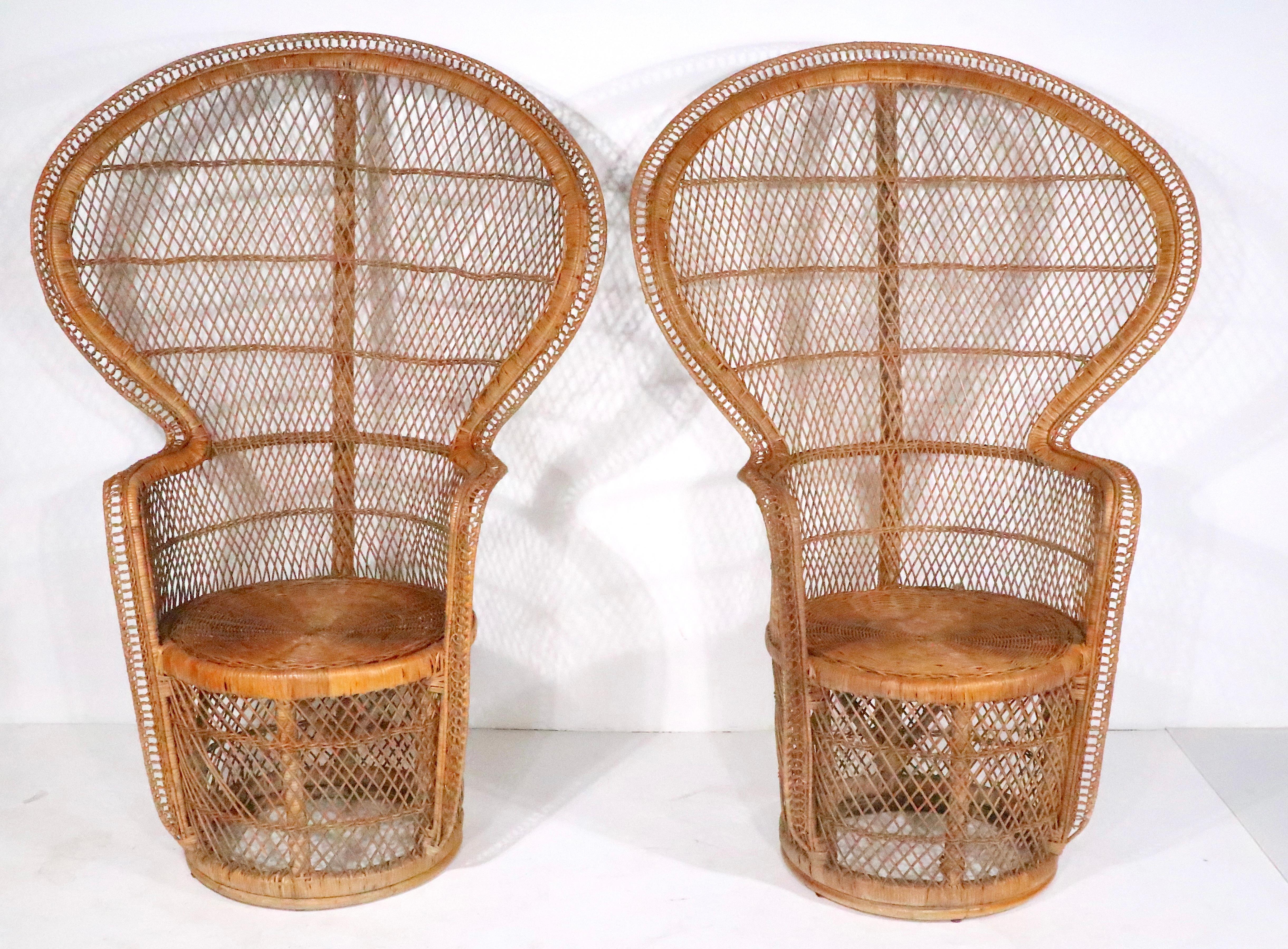 Pr. woven  wicker fan backs chairs, know as the Emanuelle chair. Hard to find  these chairs in good original, clean and ready to use  condition, very hard to find them in pairs. Matched set of vintage Emanuelle chairs, offered and priced as a pair.