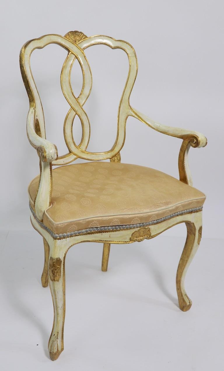 Exceptional pair of armchairs by Florentine Furniture, having an antique white ground with gold gilt trim. Both are in good, original untouched estate condition, structurally sound and sturdy, upholstery as is. Chairs in this style are not often