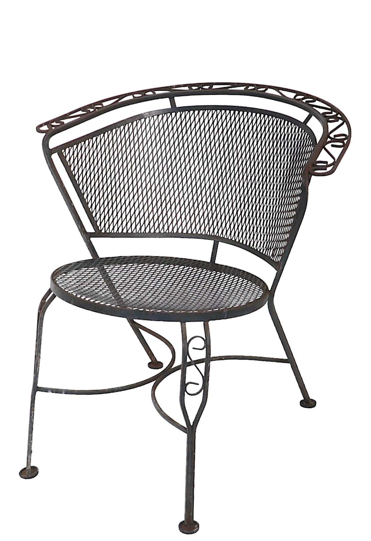 Pair of vintage wrought iron garden, patio, poolside chairs by the Woodard Furniture Company, circa 1950/60's. Both chairs are in very good, clean, ready to use condition, showing only light cosmetic wear, normal and consistent with age. Usable as