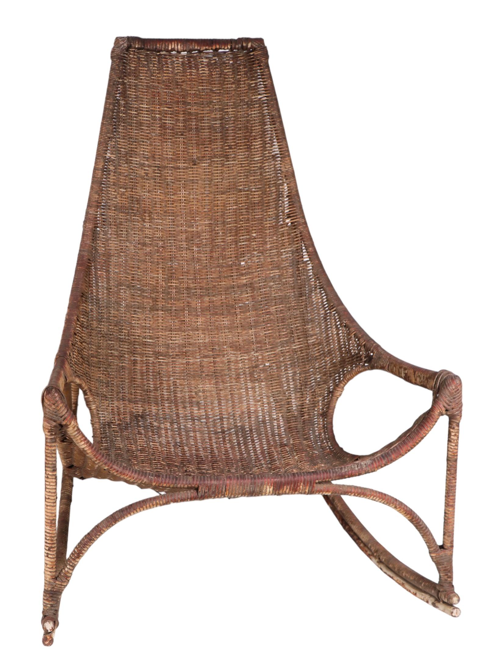 Chic pair of wicker rocking chairs designed by Francis Mair, circa 1950/1960's. 
 These sophisticated chairs are both stylish, and extremely comfortable. Both are structurally sound and sturdy, both show cosmetic wear, notably wear to the finish,