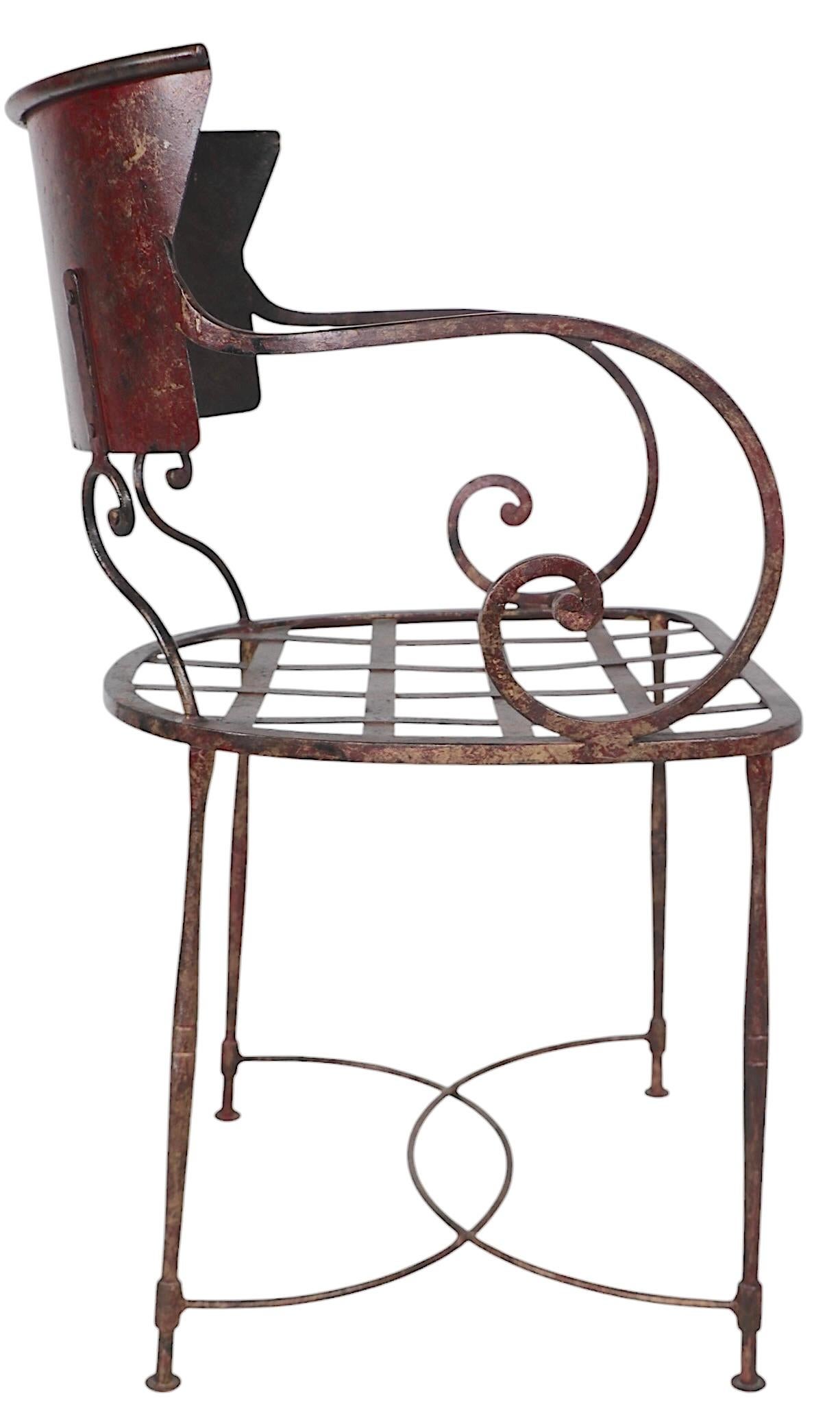 Chic pair of wrought iron chairs by Arhaus - Made in Italy circa 1950/70's. The chairs feature a curved scoop form  backrest, scrolled arm rests, woven strap work seat, and an elegant wrought iron frame. Both chairs are in very good, original, clean