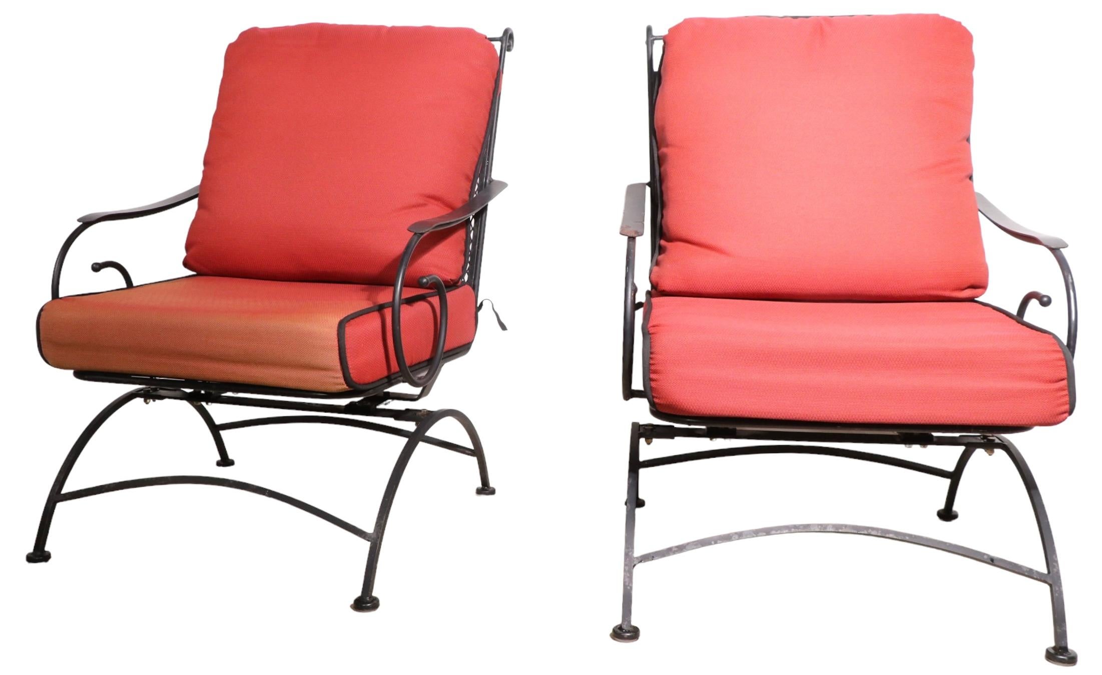 Pair of stylish platform rockers constructed of wrought iron, with metal mesh seats, and backs. The chairs ae complete with removable indoor outdoor cushions, they are clean and ready to use, showing only light cosmetic wear, normal and consistent