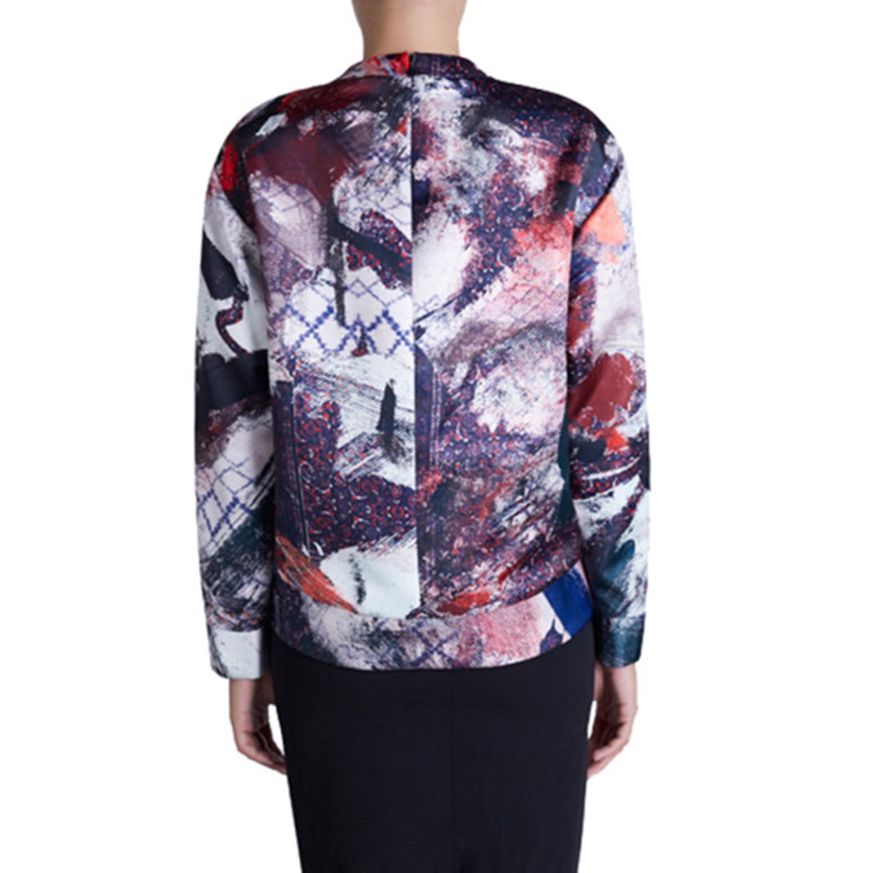 Designed with an artistic print, this Prabal Gurung sweatshirt is stylish and calm. Its satin exterior is designed with shades of purple, pink, and grey, featuring long sleeves and a round neckline. This item does not include the accessories shown