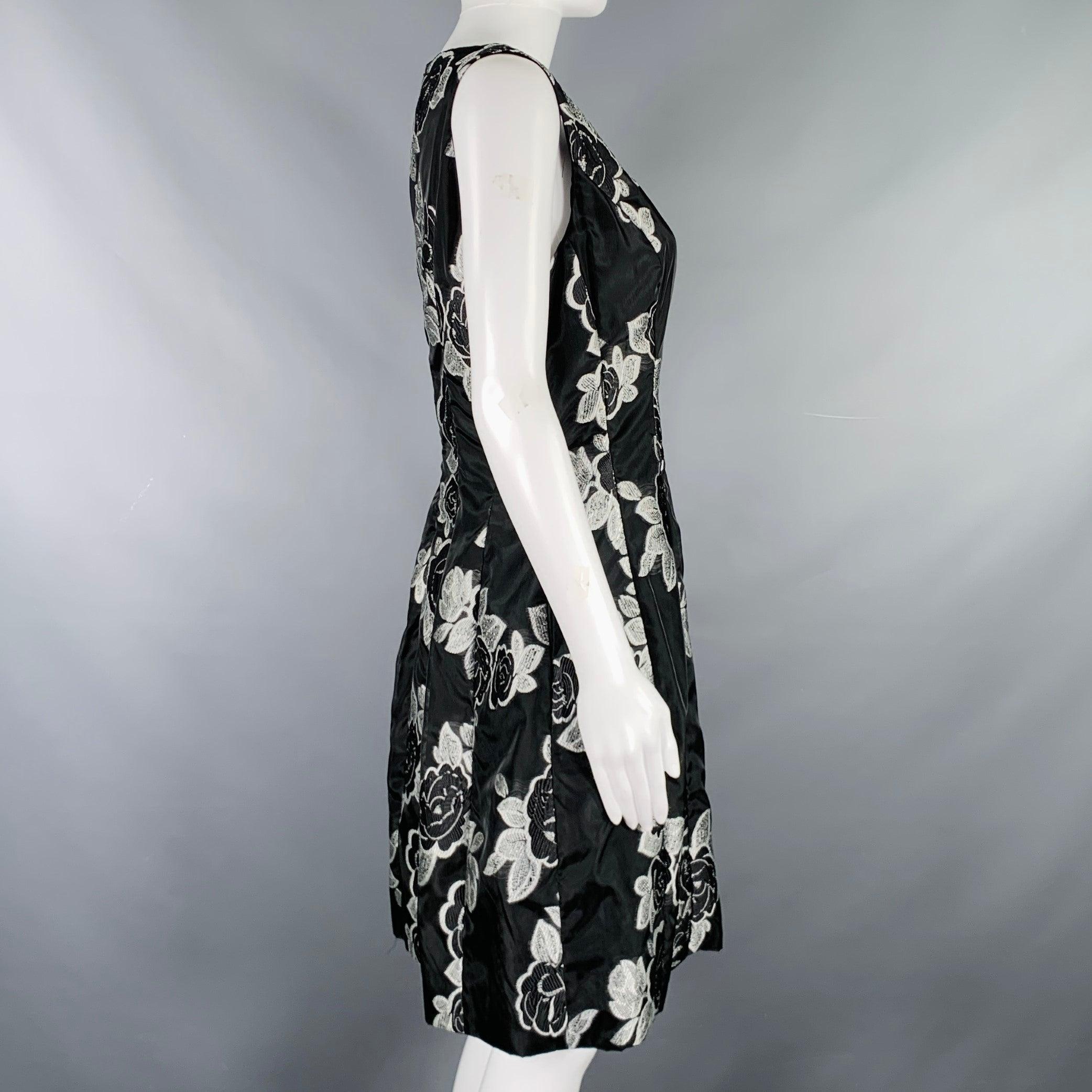 PRABAL GURUNG dress
in a black and silver polyester fabric featuring an A-line style, embroidered floral design, and invisible back zipper closure.Excellent Pre-Owned Condition. 

Marked:   10 

Measurements: 
 
Shoulder: 13 inches Bust: 36 inches