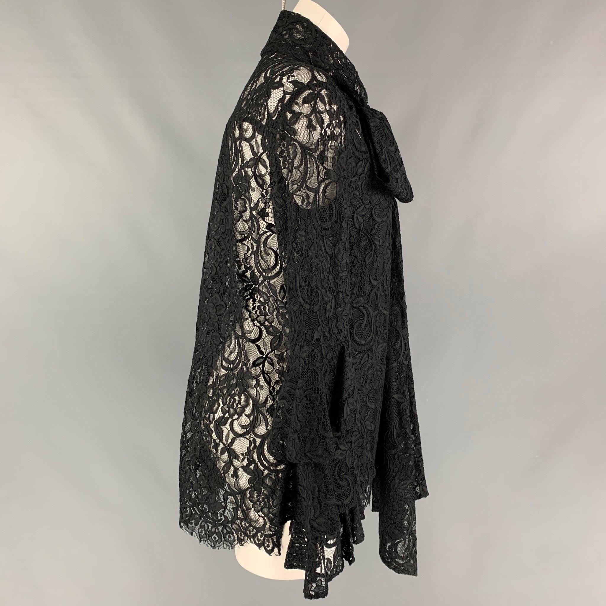 PRABAL GURUNG blouse comes in black nylon and cotton lace featuring a tie up bow and ruffled sleeves. Excellent Pre-Owned Condition. 

Marked:   4 

Measurements: 
 
Shoulder: 16.5 inches Bust: 41 inches Sleeve: 25 inches Length: 29 inches  
  
  
