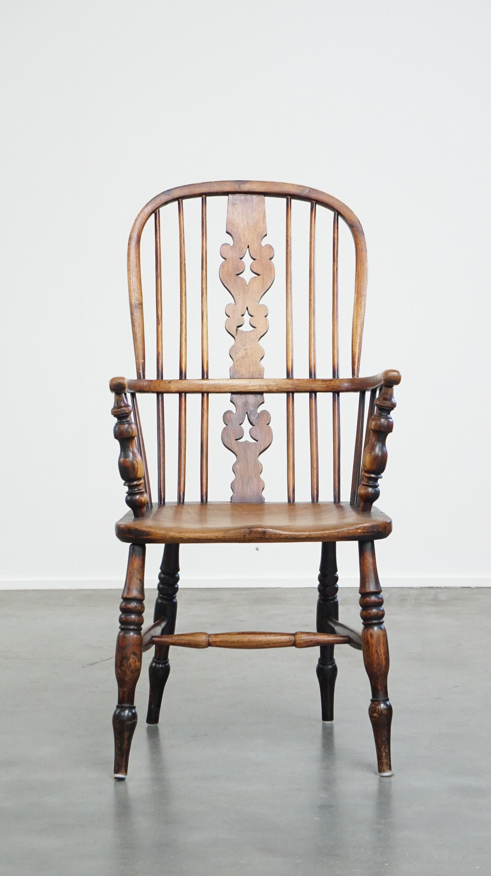 This beautiful antique Windsor dining chair has developed a wonderful patina over the years. It features a spindled backrest and a beautifully shaped seat. Not only is it functional, but it also adds a lovely touch of elegance to nearly any