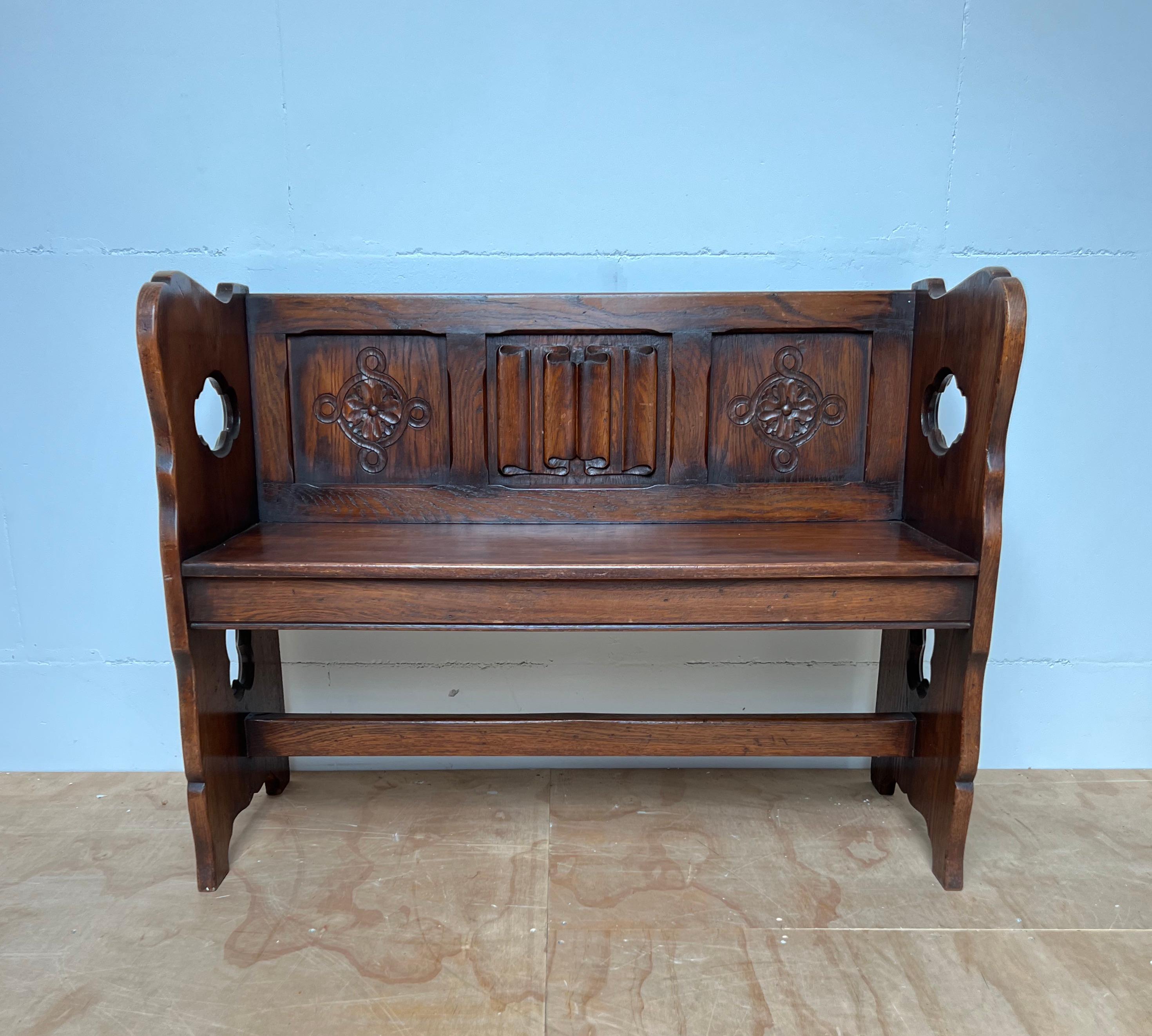 Rare Gothic bench with top quality carved, church letter panel and more.

This beautifully hand carved, oak church bench from the early 1900s is in amazing condition. It comes with top quality carved details including the hand carved quatrefoil