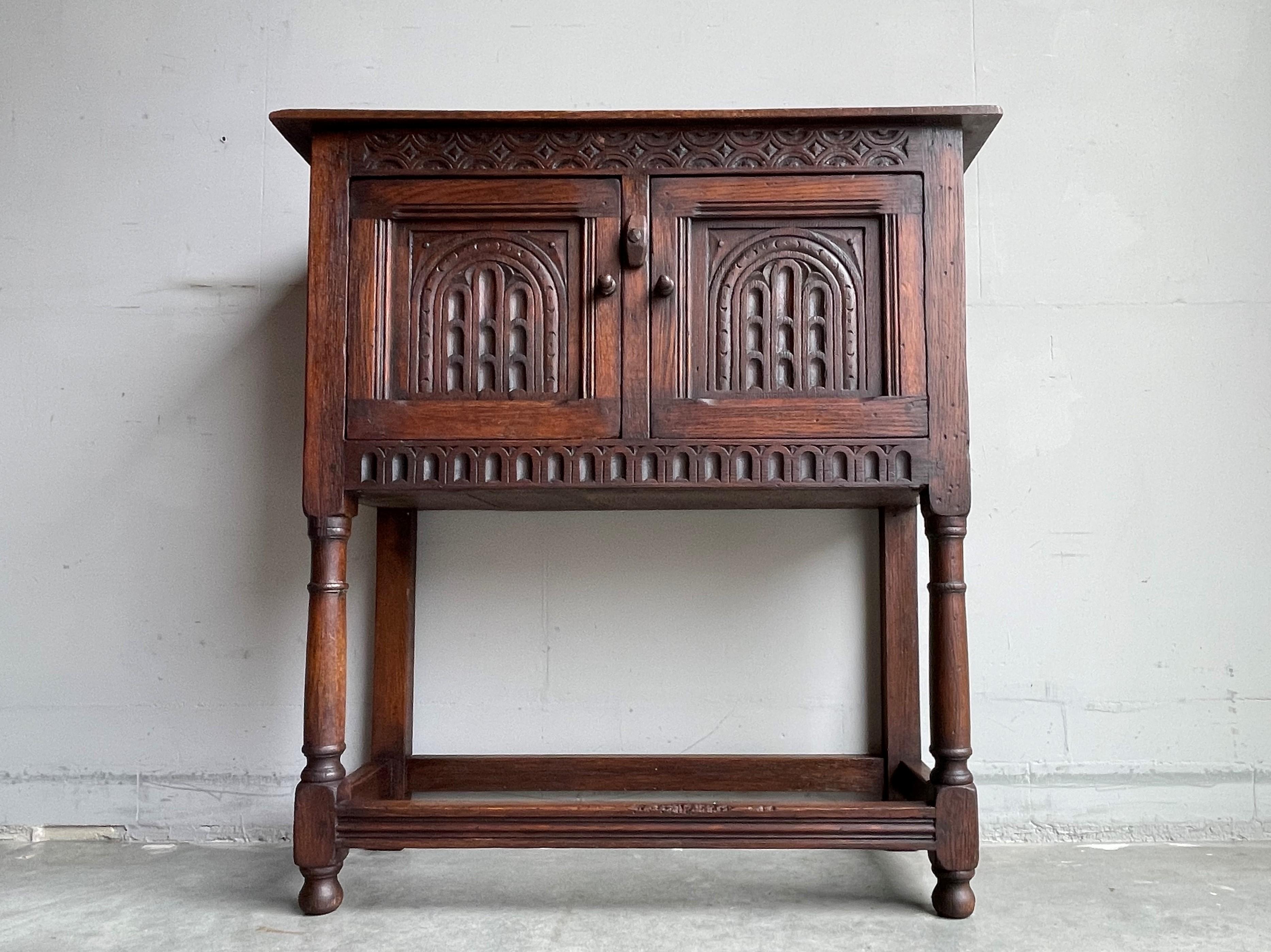 Beautiful and practical Size, hand carved Gothic cabinet with church window-like panels.

This antique Gothic Revival cabinet can be placed tight on your wall and thanks to its undeep design this medieval style beauty can be placed almost anywhere