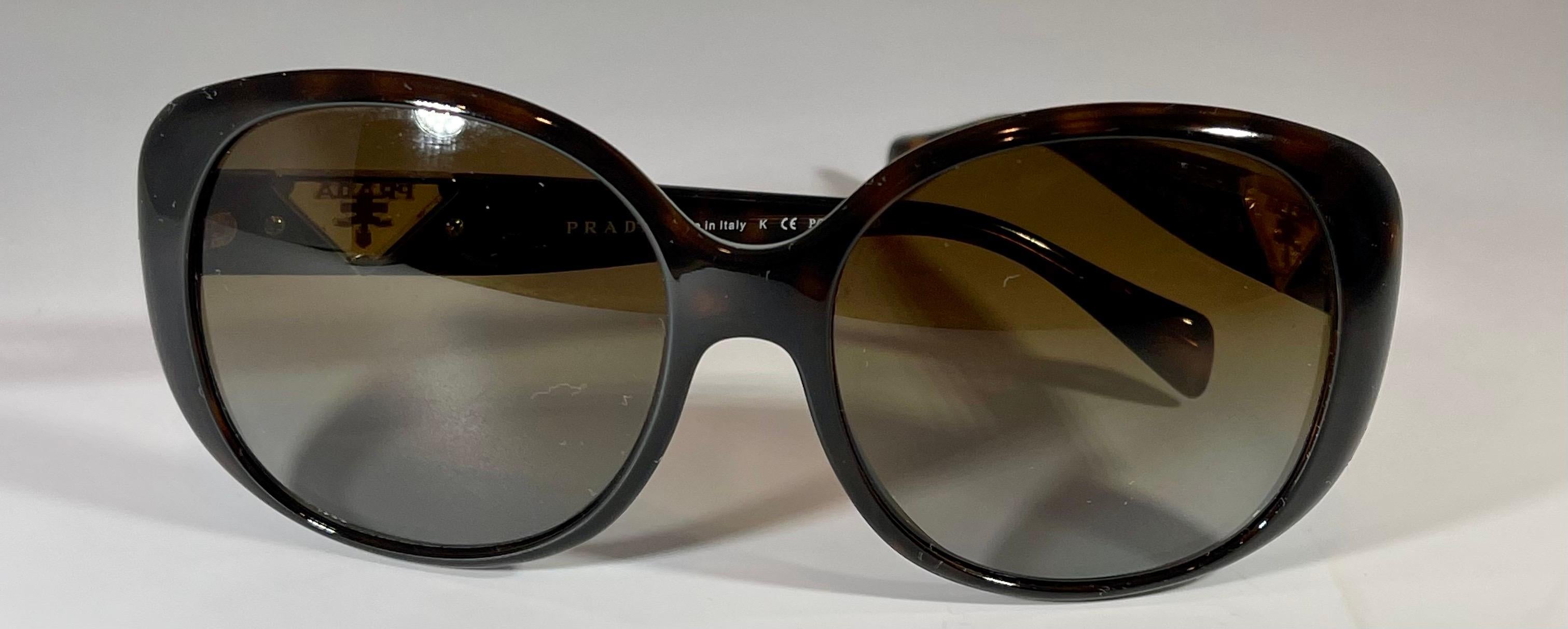 
Prada  15057 16 2AU-6E1 135 3P  Brown Women Sunglasses, Preloved Excellent, Polarized
Made in Italy
Brown Women Sunglasses, Medium to Large  size
Dark Brown shade of lenses
Pre Loved 
No box from Prada
all pictures of the original sunglass
Prada