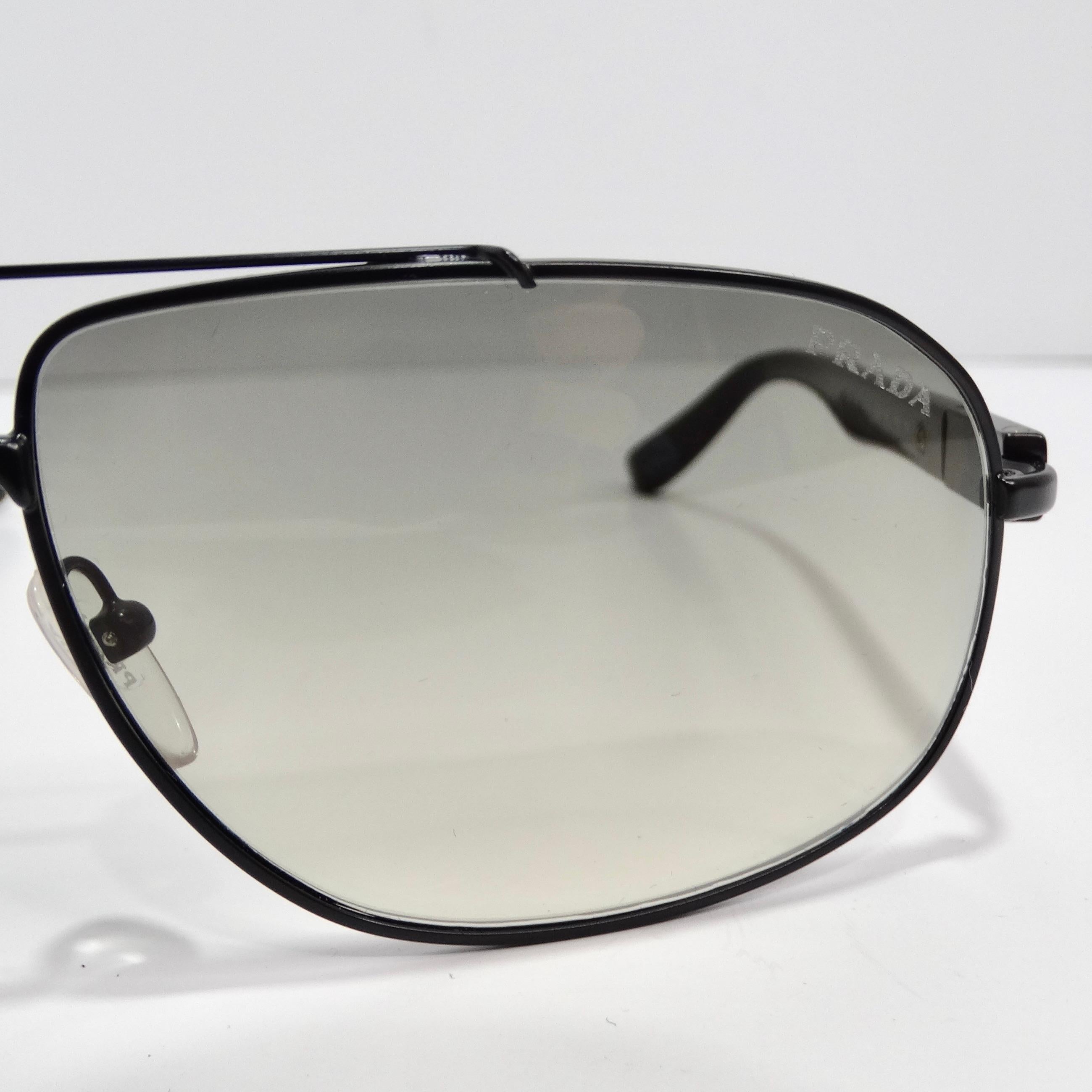 Enter the realm of timeless chic with the Prada 1990s Black & Blue Tortoise Aviator Sunglasses, a classic aviator style that effortlessly combines sophistication with a touch of contemporary flair. These sunglasses feature thin black rims and arms