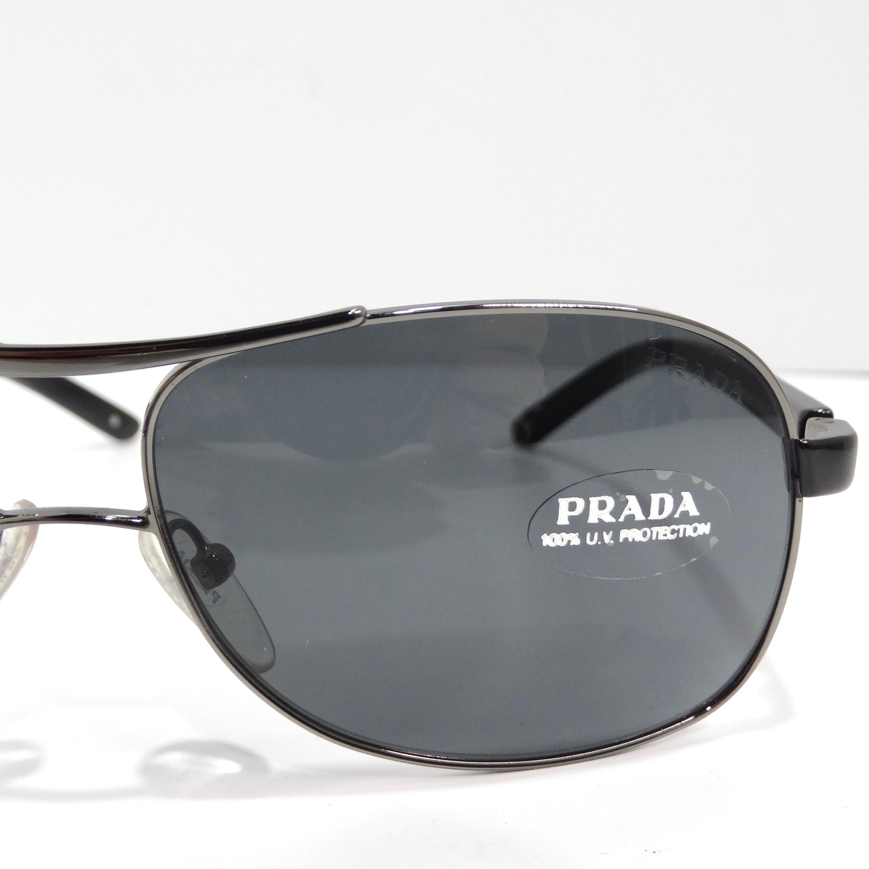 Step into timeless elegance with the Prada 1990s Silver Tone Aviator Sunglasses, a classic aviator style that effortlessly combines sophistication with enduring style. These sunglasses feature thin silver-tone rims, complemented by black arms