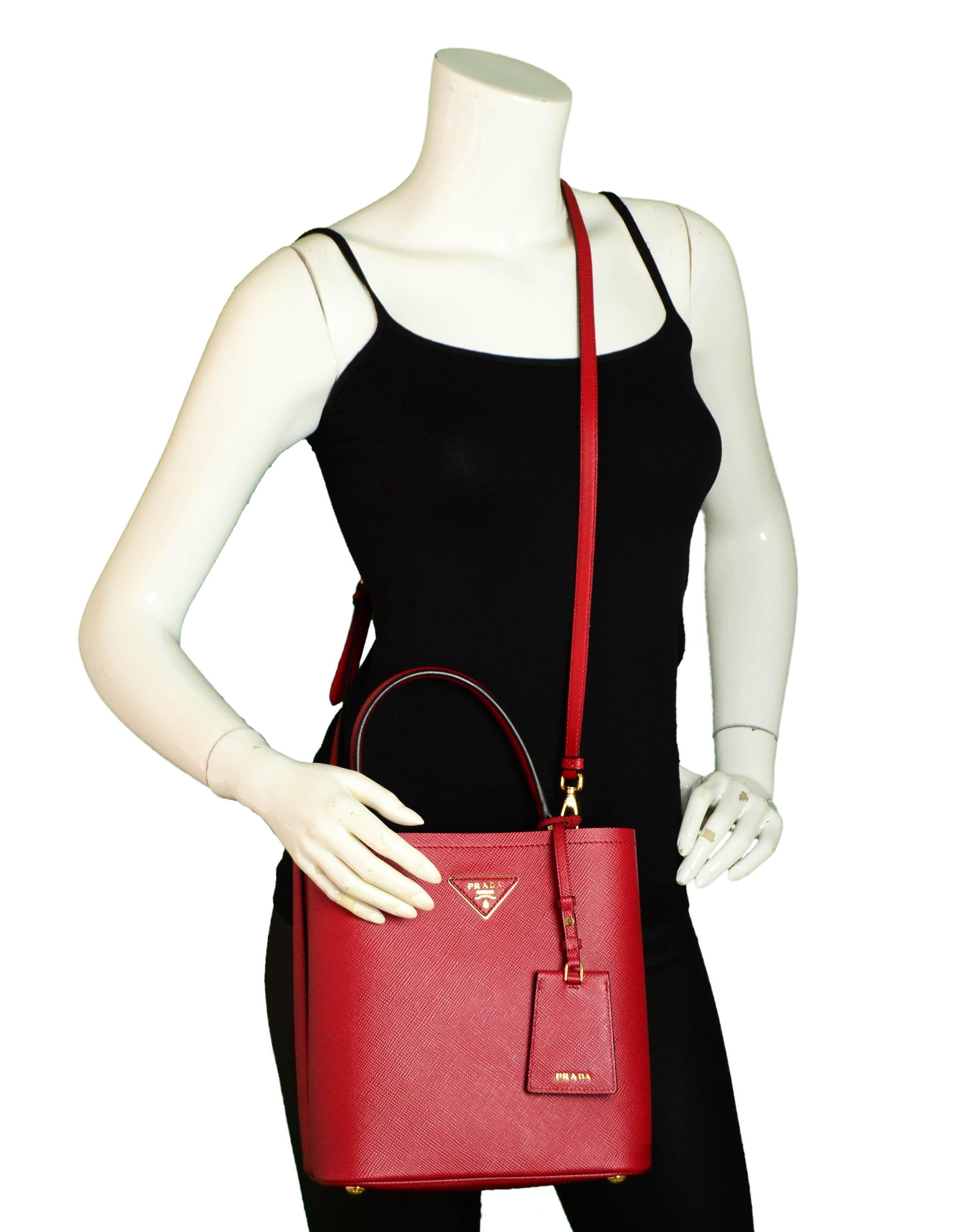 Prada 1BA212 Fuoco Red/Nero Black Medium Saffiano Leather Panier Bag

Made In: Italy
Color: Fucco red/nero
Hardware: Goldtone
Materials: Saffiano leather
Lining: Leather
Closure/Opening: Magnetic snap
Interior Pockets: Middle slit divides bag into