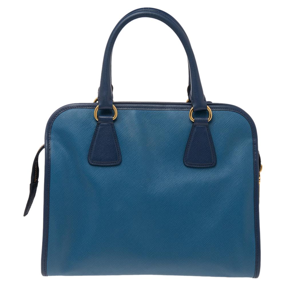 Characterized by a unique dome shape, this satchel from the house of Prada is a chic way to carry your everyday essentials in style. Elegantly crafted from Saffiano soft leather, this bag adds an exquisite touch to your casual attire and makes sure