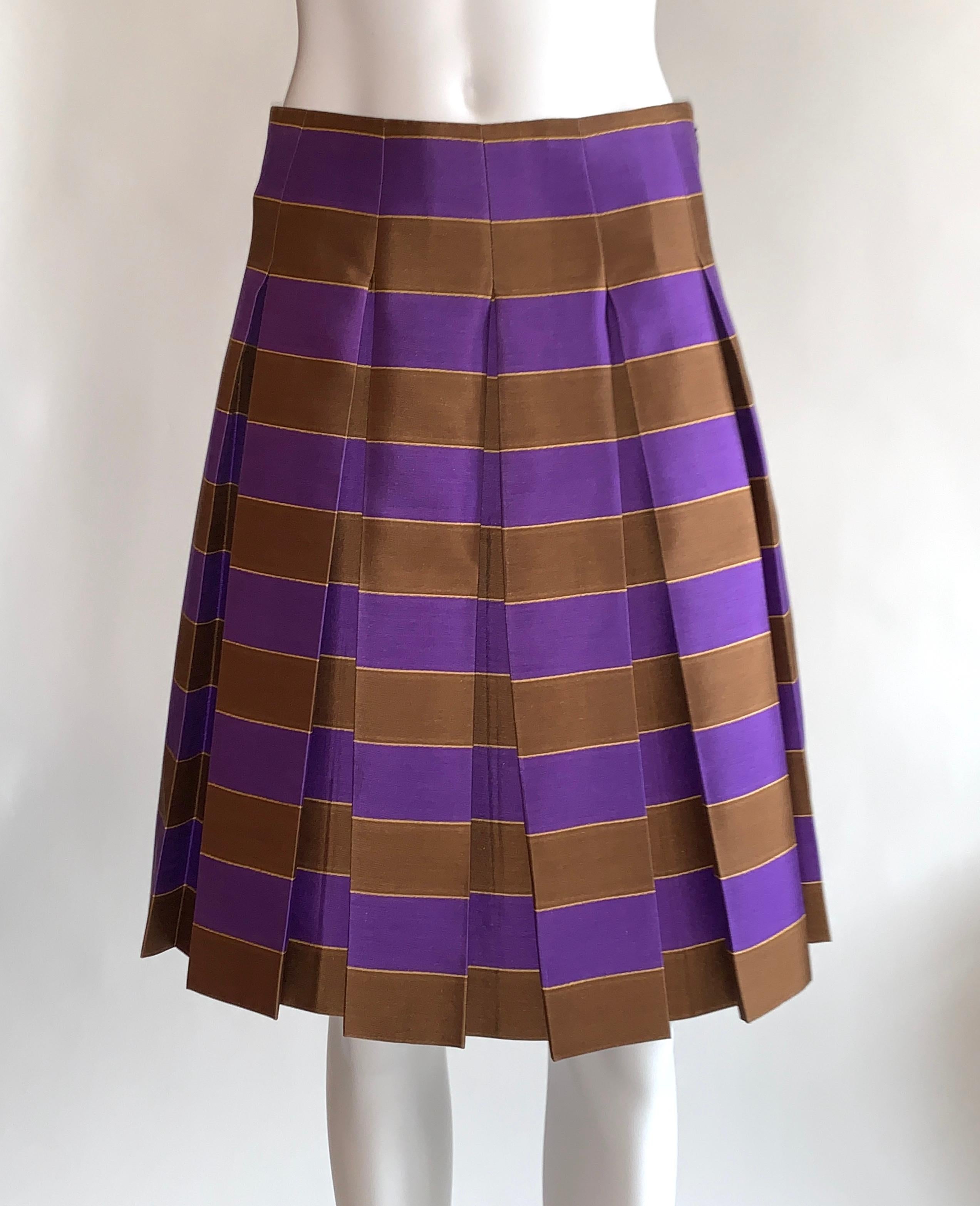 Prada pleated A line skirt in purple and brown stripes with golden yellow accent stripe. Side zip and hook and eye. 

As seen in orange color way of Prada Spring 2005 show, look 25.

58% wool, 42% silk.

Made in Italy. Size IT 38, approximate US 2.