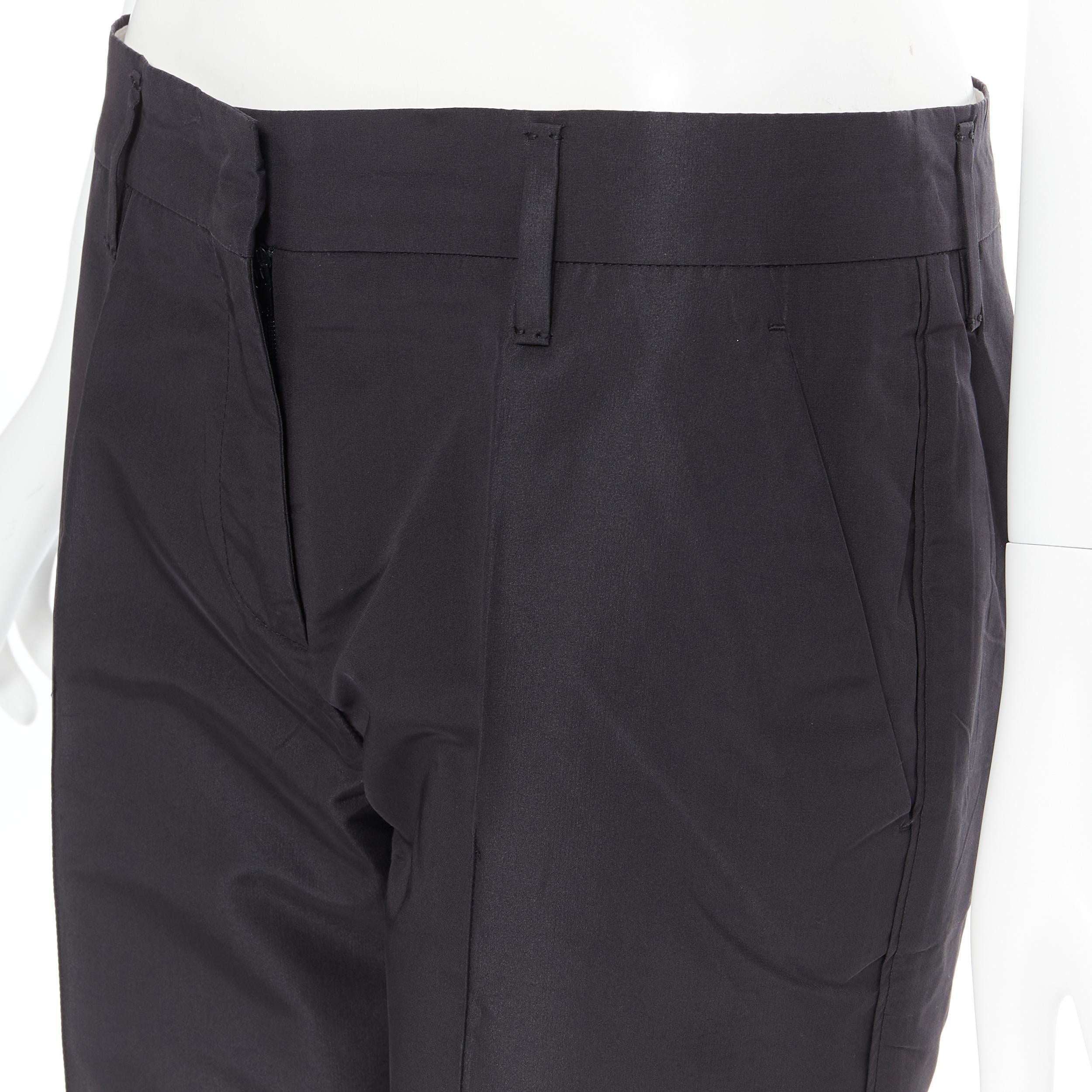 PRADA 2009 black silk polyester pleat front 4-pocket trousers pants IT40 
Reference: PYCN/A00065 
Brand: Prada 
Designer: Miuccia Prada 
Collection: 2009 
Material: Silk 
Color: Black 
Pattern: Solid 
Closure: Zip 
Extra Detail: Hook bar zip fly.