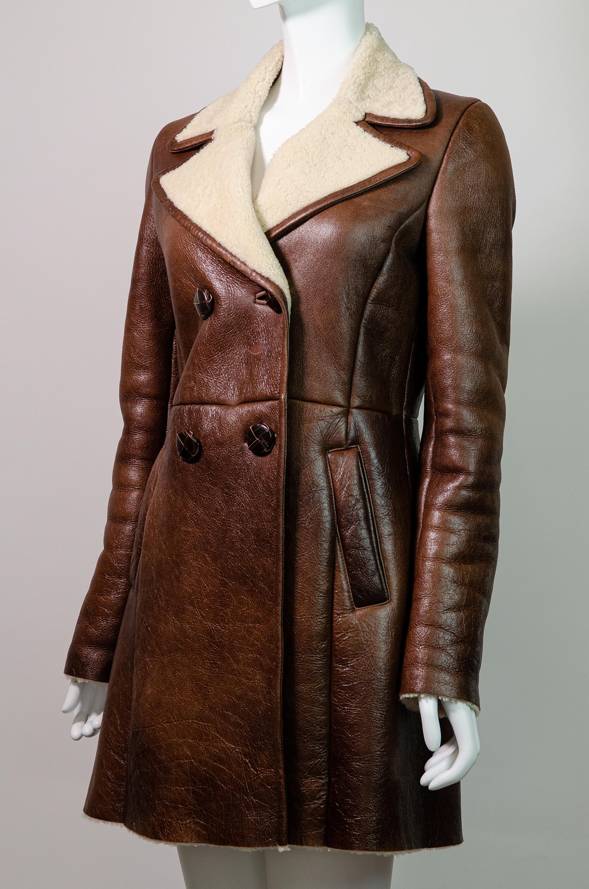 The most amazing Prada shearling double breasted coat from 2010.

This gorgeous Prada double breasted coat is fully lined in shearling - it will certainly keep you warm in the cooler months. Very 1970s in its design, this warm-toned brown coat