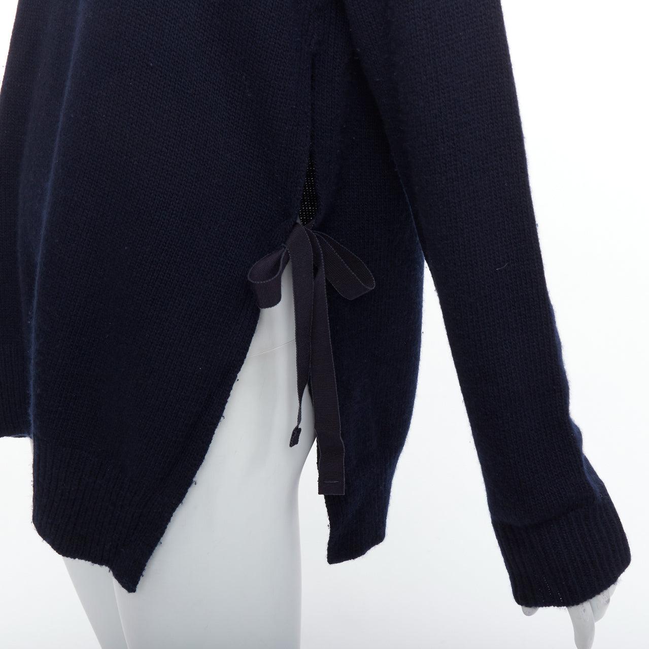PRADA 2016 navy wool cashmere ribbon tie side crew neck sweater IT42 M
Reference: PYCN/A00140
Brand: Prada
Designer: Miuccia Prada
Collection: 2016
Material: Wood, Cashmere
Color: Navy
Pattern: Solid
Closure: Self Tie
Extra Details: Ribbon tie