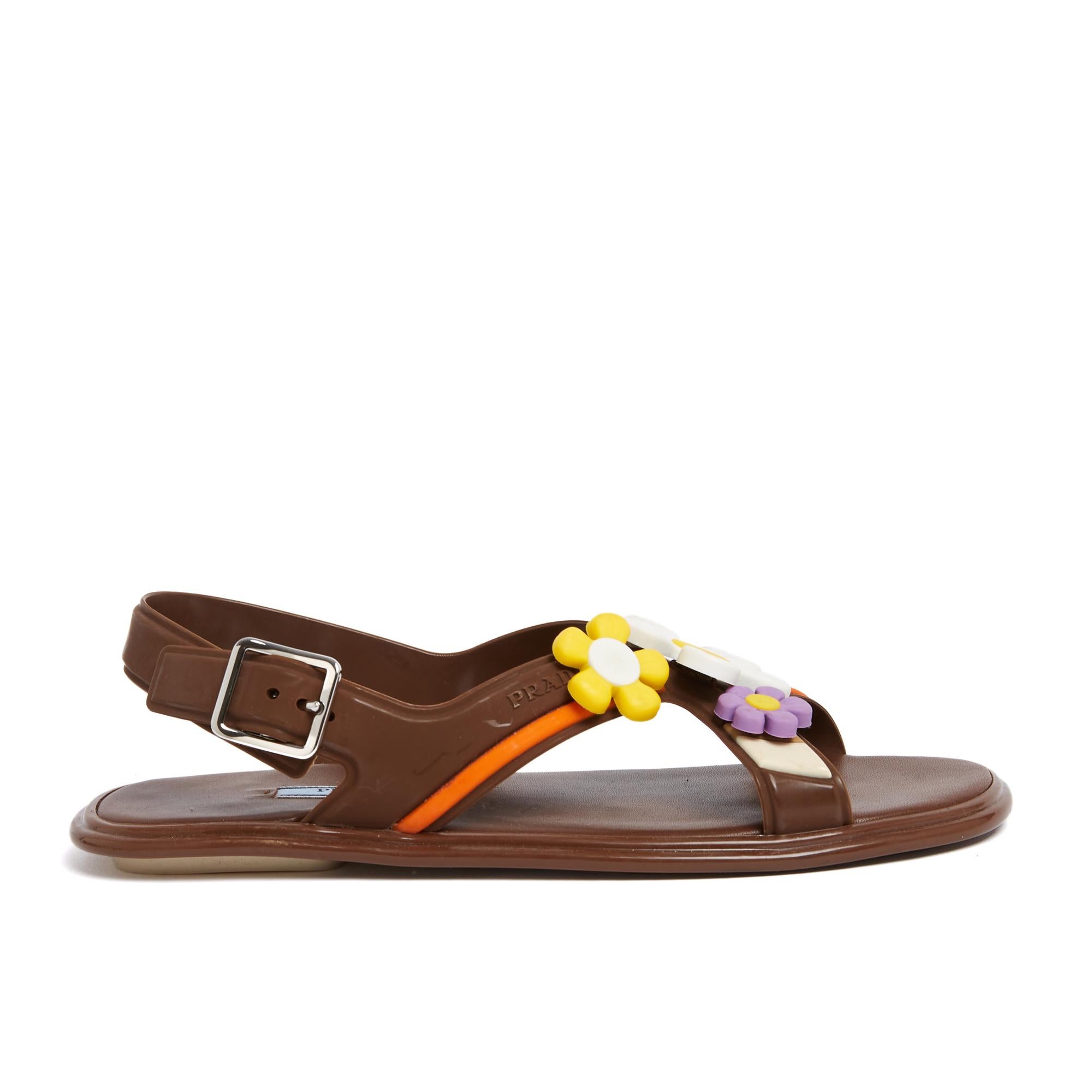 Prada sandals from the SS 2017 collection in light brown soft plastic with wide straps decorated with multicolored flowers. Size 38EU or UK5 and US7.5 cm. The sandals are in excellent condition, probably never worn outdoors, charming look for sunny